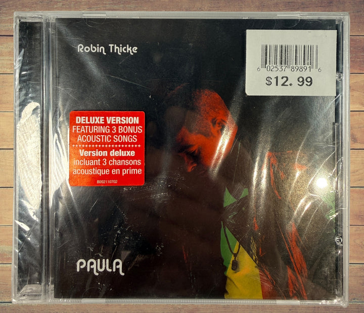 Sealed deluxe CD edition of Robin Thicke’s 2014 album Paula featuring three acoustic bonus tracks. Original retail copy in shrink wrap with jewel case.