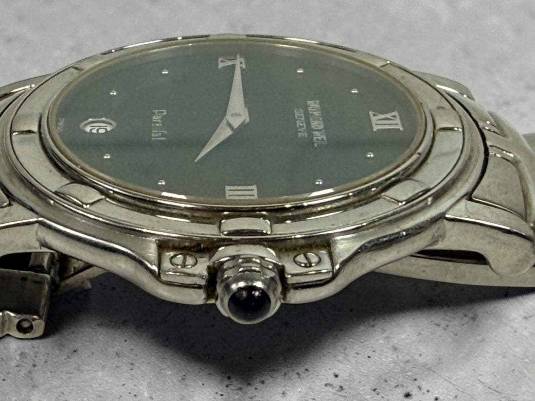 Raymond Weil Parsifal Swiss quartz watch with black dial, Roman numerals, and steel bracelet. Classic luxury design with date display, everyday wearable style.