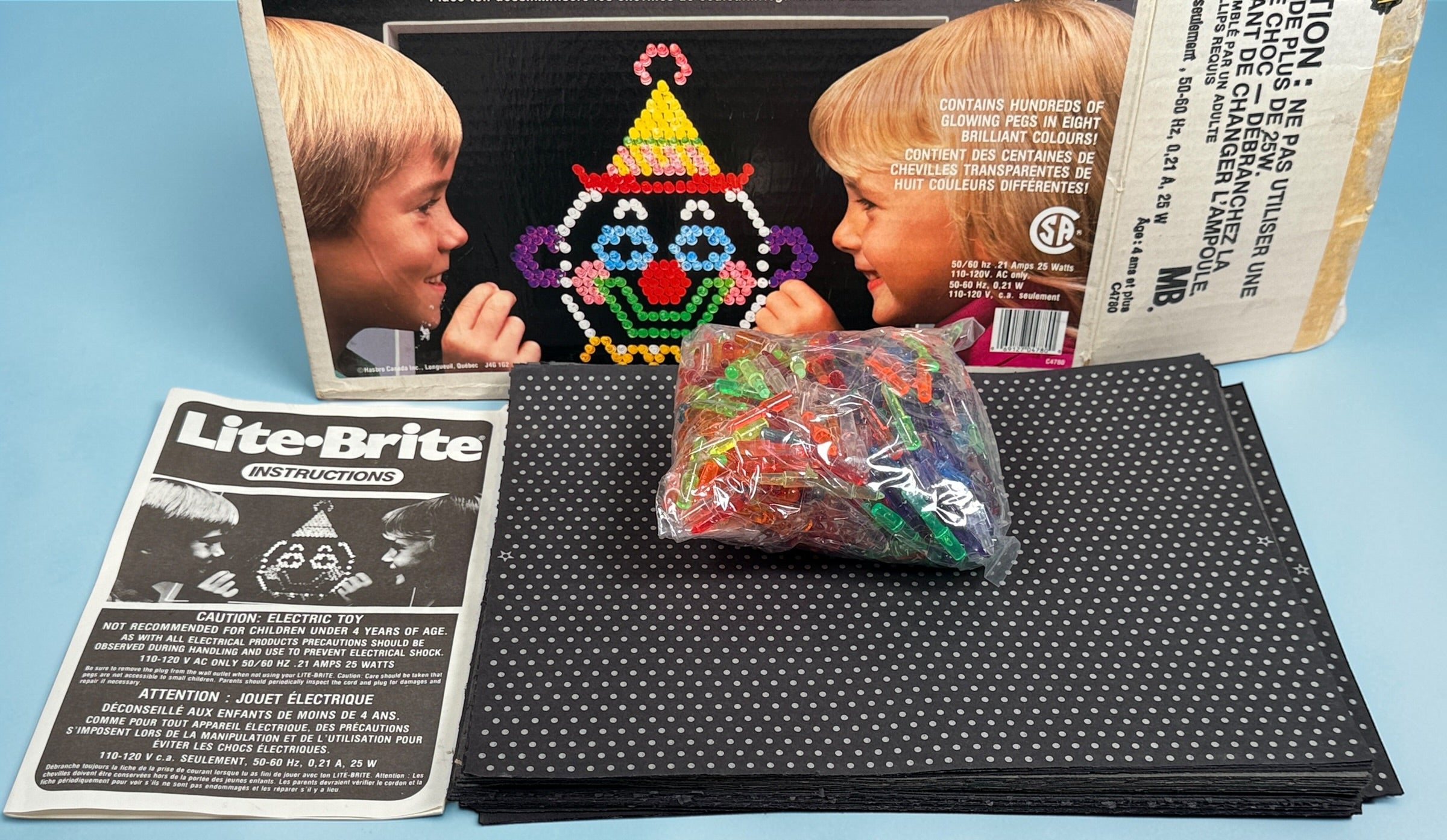 Vintage 1987 Lite-Brite Milton Bradley C4780 boxed set with pegs, 22 design sheets, and 20 blanks. Classic retro toy in very good condition.