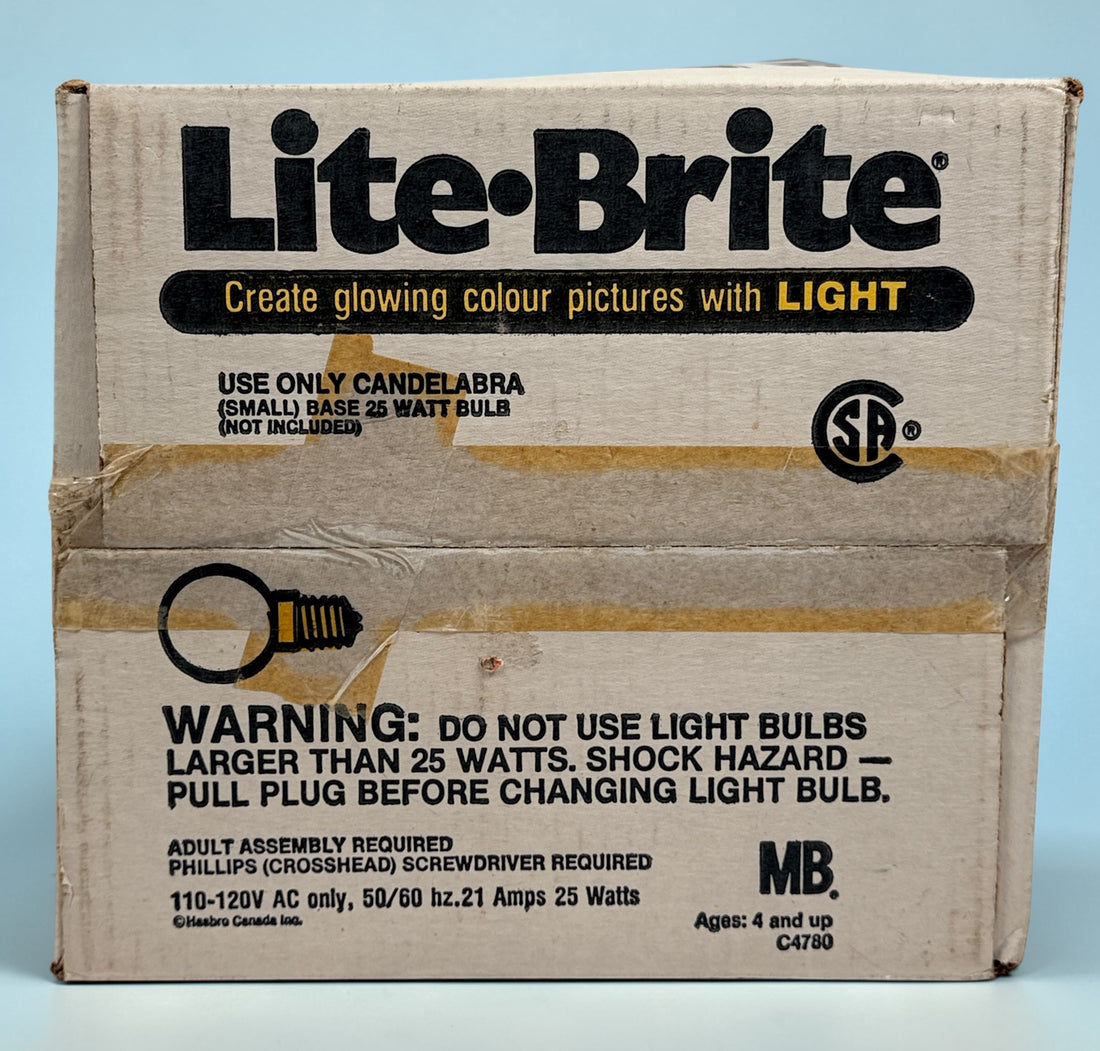 Vintage 1987 Lite-Brite Milton Bradley C4780 boxed set with pegs, 22 design sheets, and 20 blanks. Classic retro toy in very good condition.