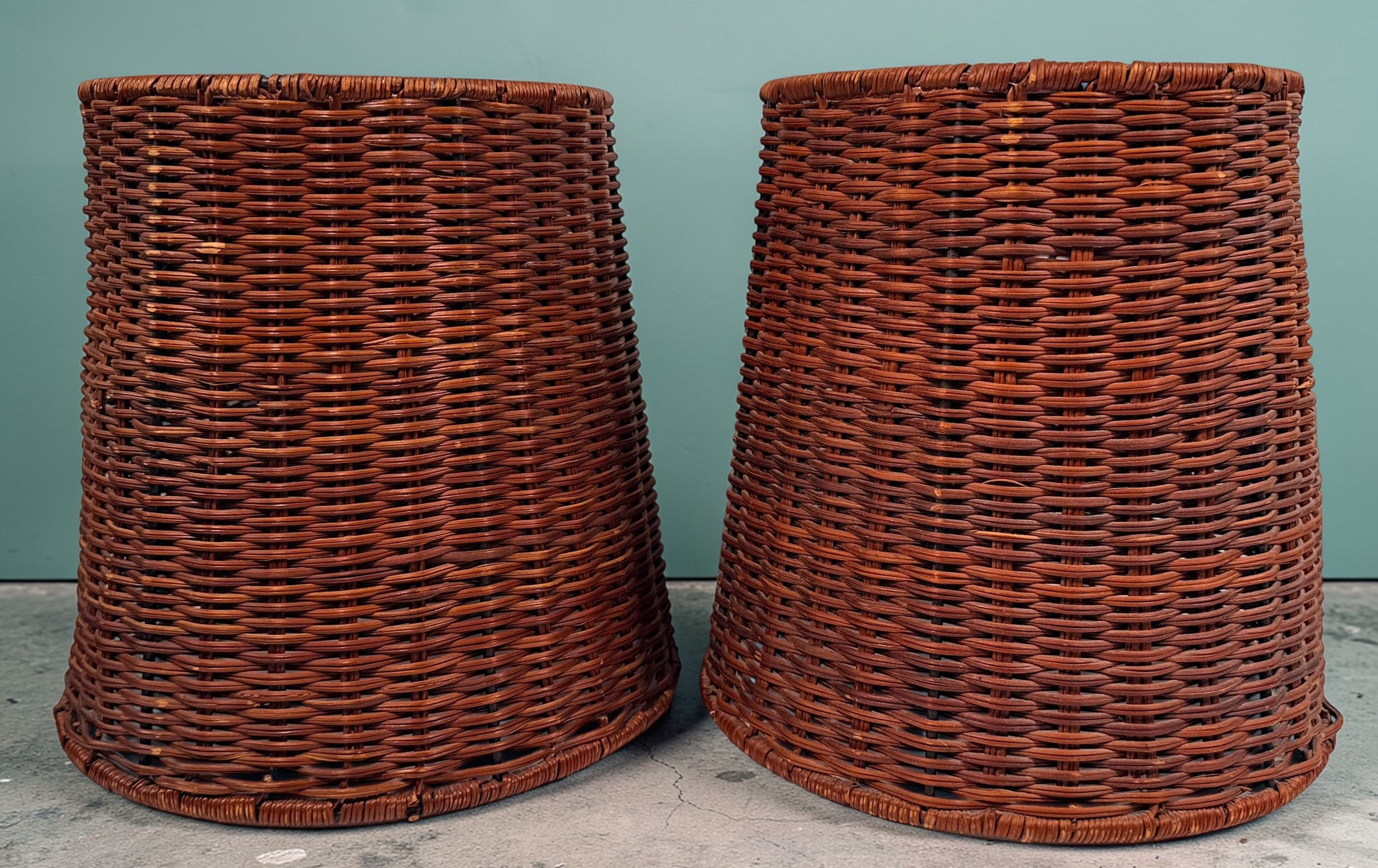 Pair of vintage rattan lamp shades in woven boho style. Drum shape with spider fitter, perfect for table or floor lamps and warm natural decor interiors.