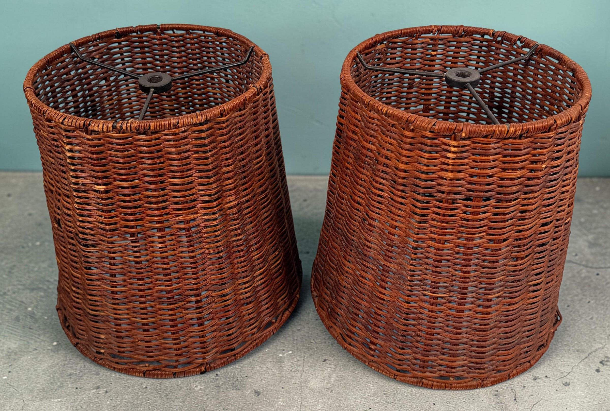 Pair of vintage rattan lamp shades in woven boho style. Drum shape with spider fitter, perfect for table or floor lamps and warm natural decor interiors.