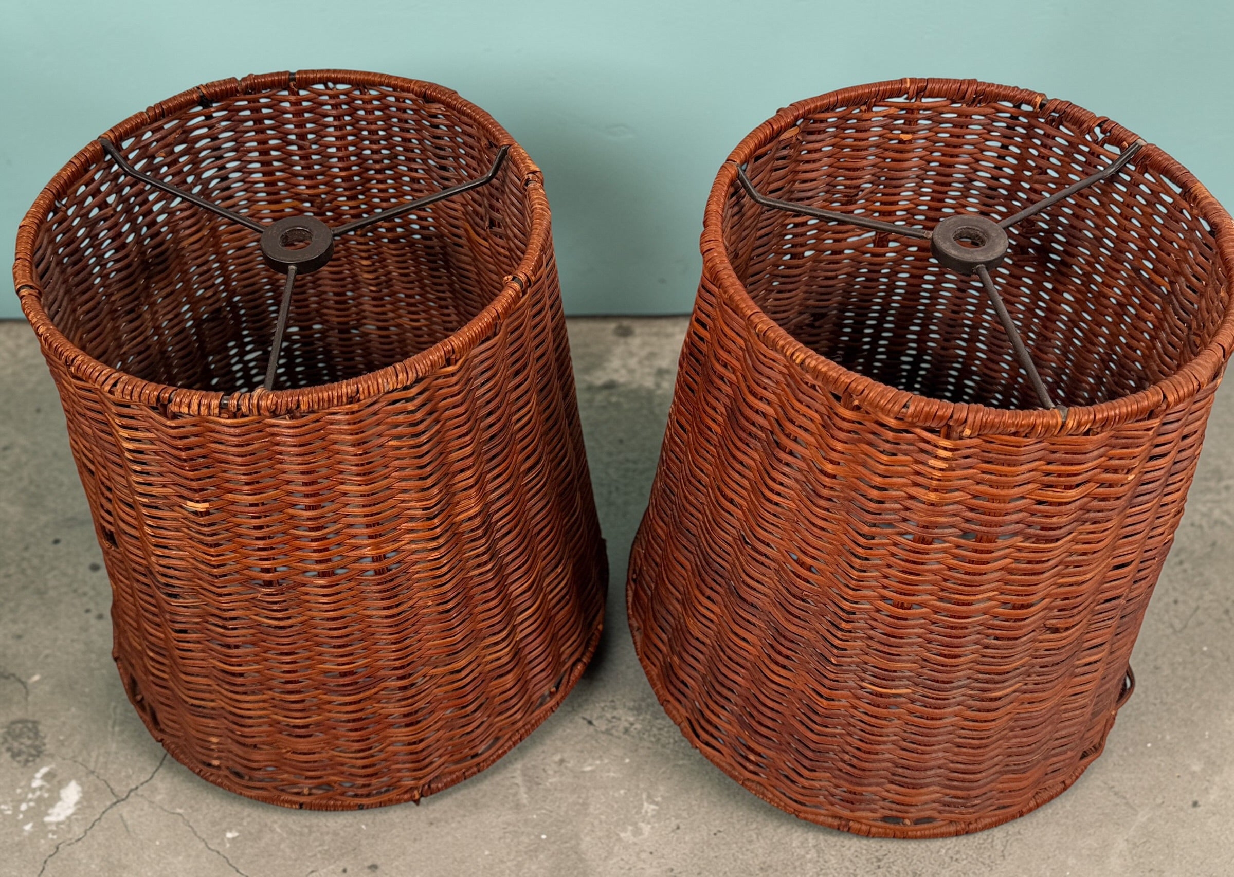 Pair of vintage rattan lamp shades in woven boho style. Drum shape with spider fitter, perfect for table or floor lamps and warm natural decor interiors.