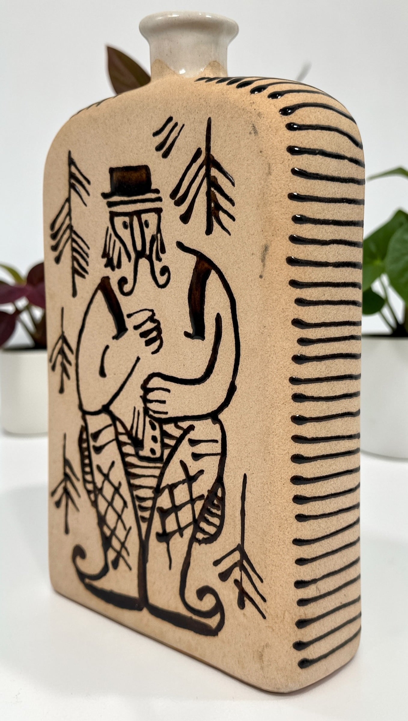 1960s LKSF Lviv Hutsul decanter bottle in majolica ceramic. Soviet-era Ukrainian folk art shtof with traditional figure and forest design.