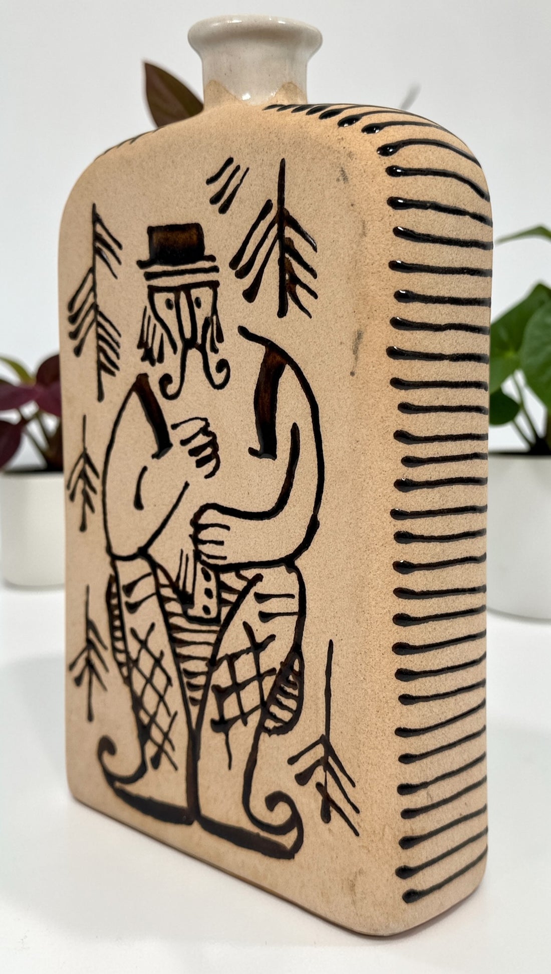 1960s LKSF Lviv Hutsul decanter bottle in majolica ceramic. Soviet-era Ukrainian folk art shtof with traditional figure and forest design.