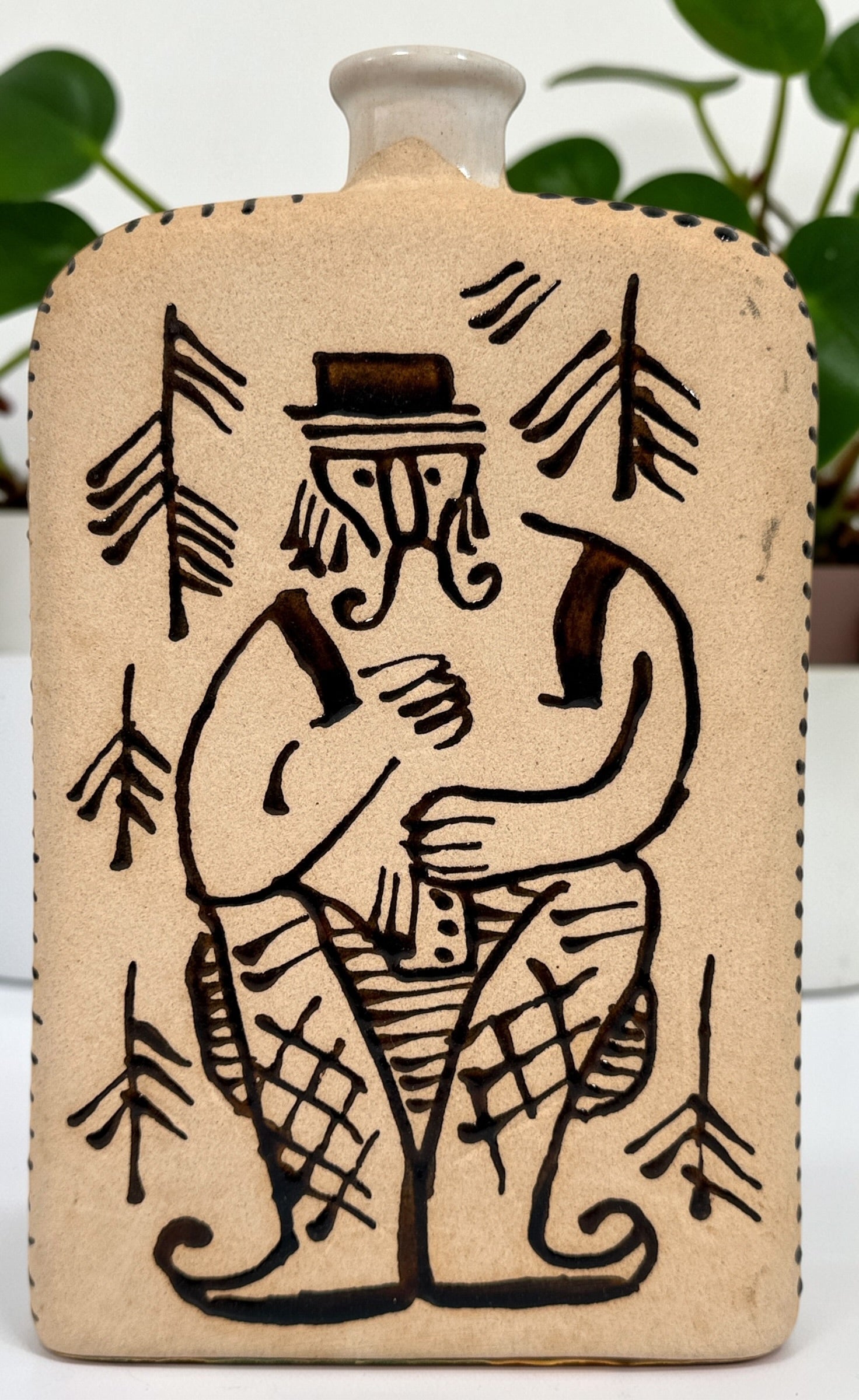 1960s LKSF Lviv Hutsul decanter bottle in majolica ceramic. Soviet-era Ukrainian folk art shtof with traditional figure and forest design.