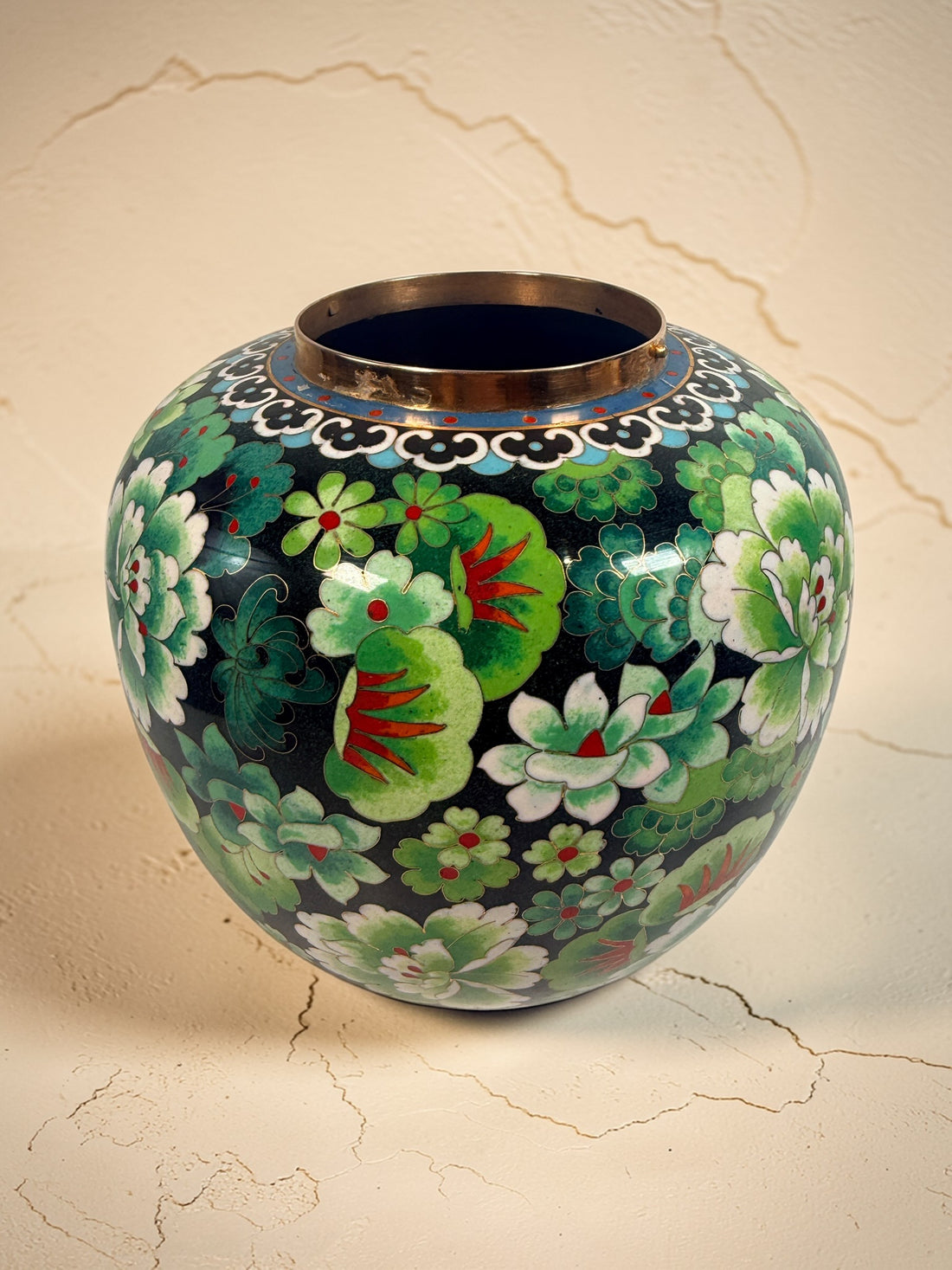 Vintage Japanese cloisonné enamel vase with floral design on black ground and turquoise interior. Decorative mid-century collectible in good condition.