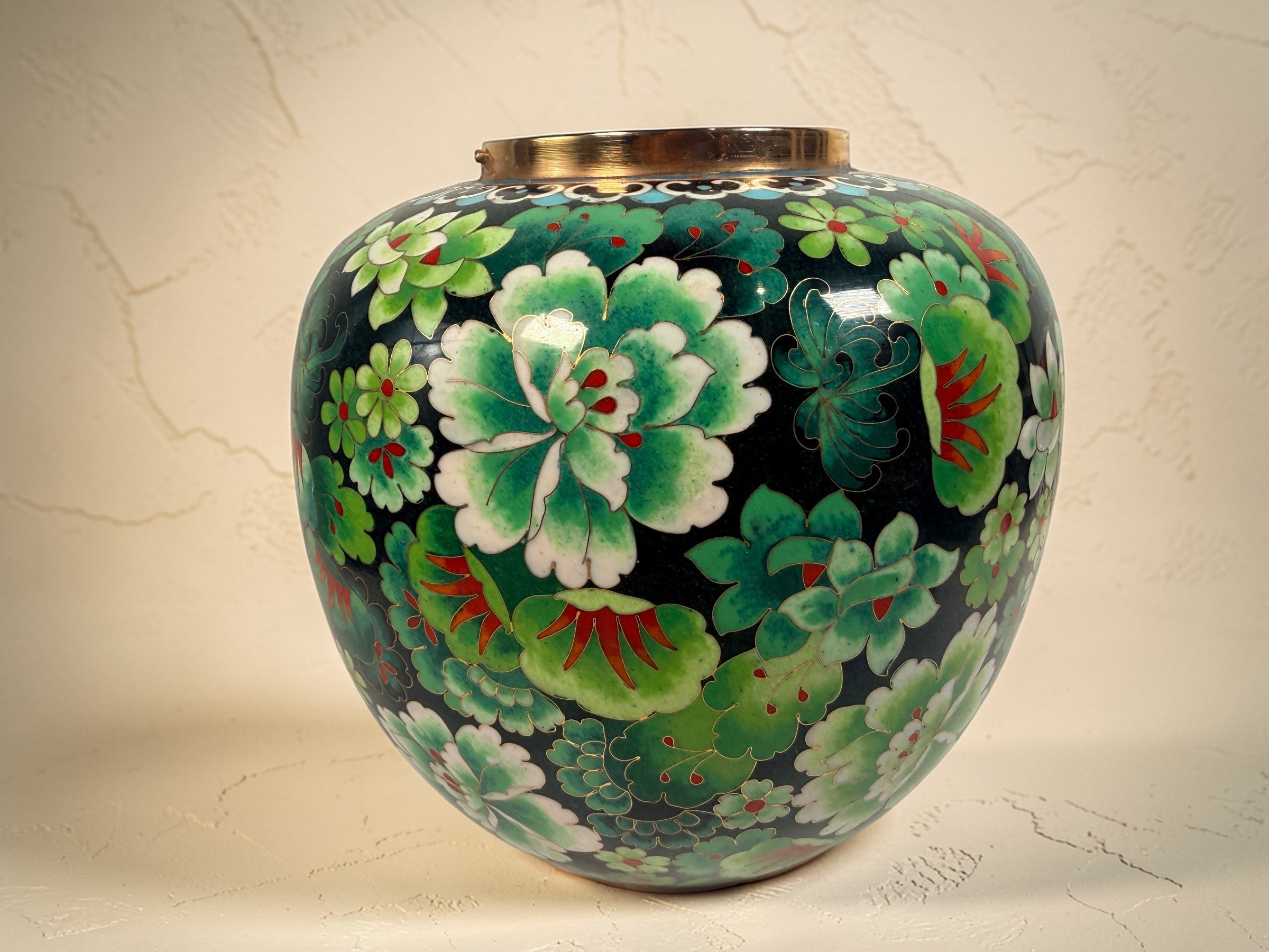 Vintage Japanese cloisonné enamel vase with floral design on black ground and turquoise interior. Decorative mid-century collectible in good condition.