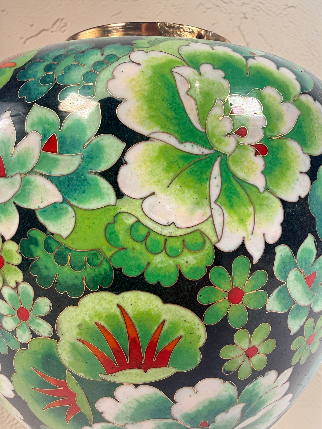 Vintage Japanese cloisonné enamel vase with floral design on black ground and turquoise interior. Decorative mid-century collectible in good condition.