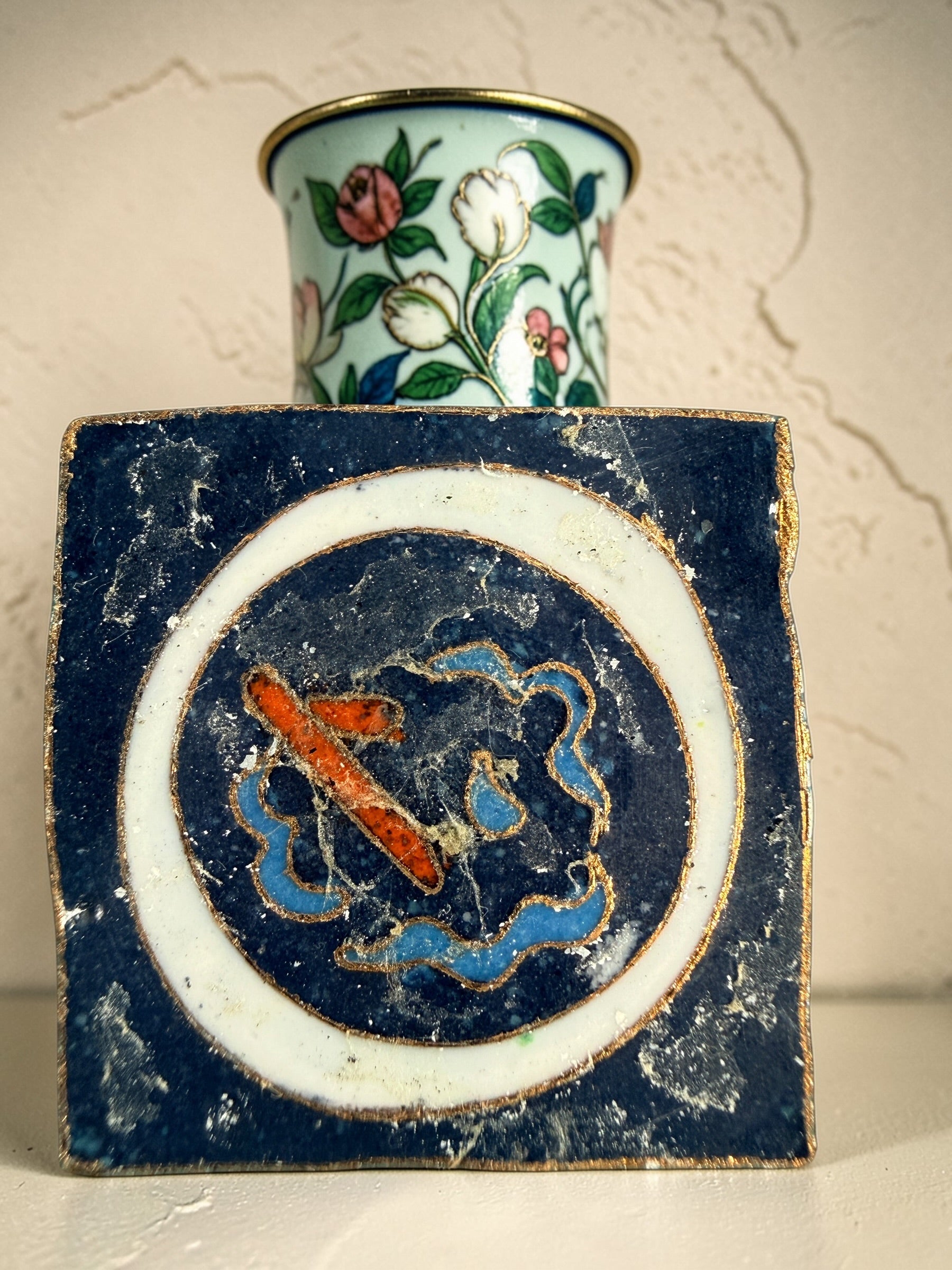Vintage Japanese cloisonné enamel vase with floral design on black ground and turquoise interior. Decorative mid-century collectible in good condition.