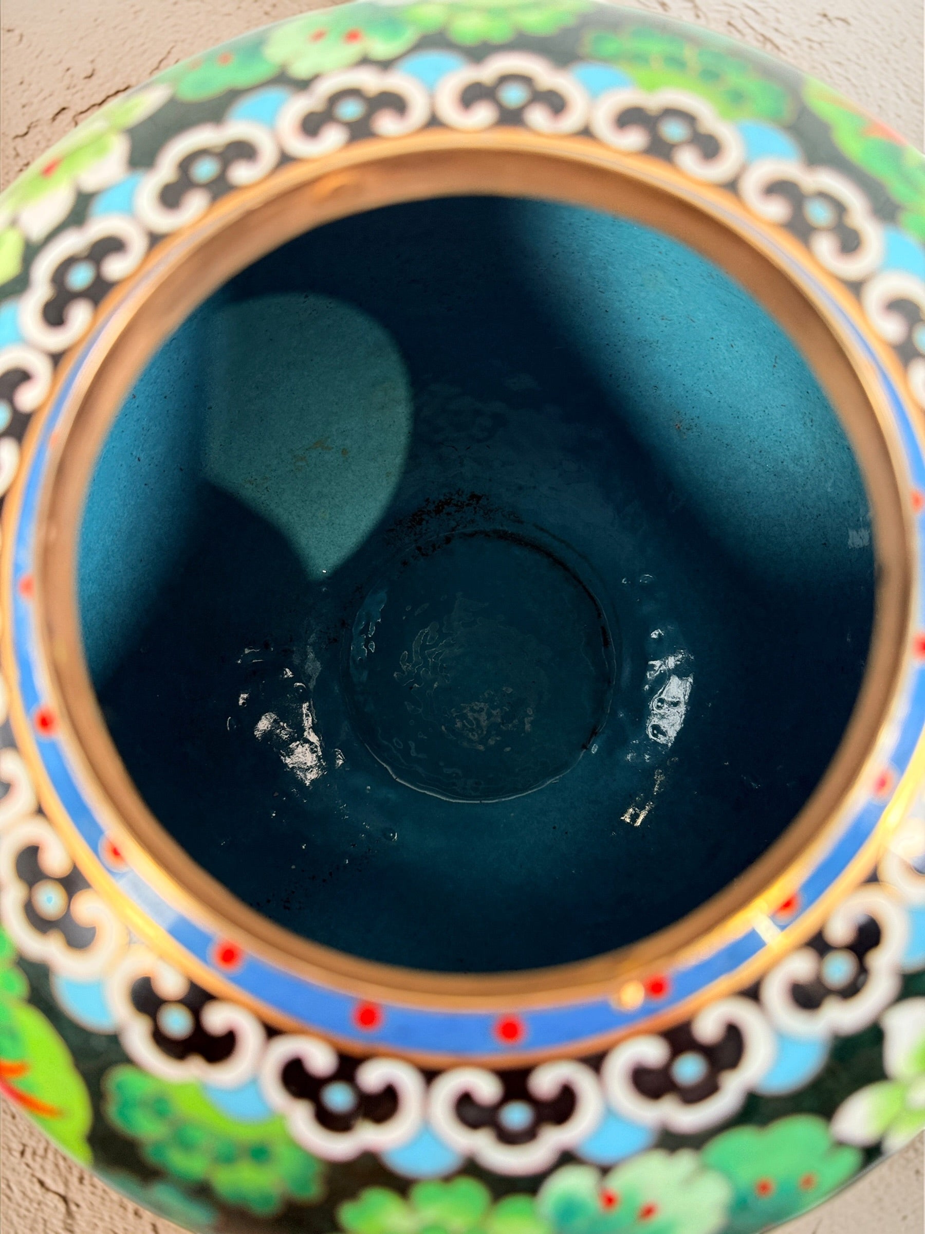 Vintage Japanese cloisonné enamel vase with floral design on black ground and turquoise interior. Decorative mid-century collectible in good condition.