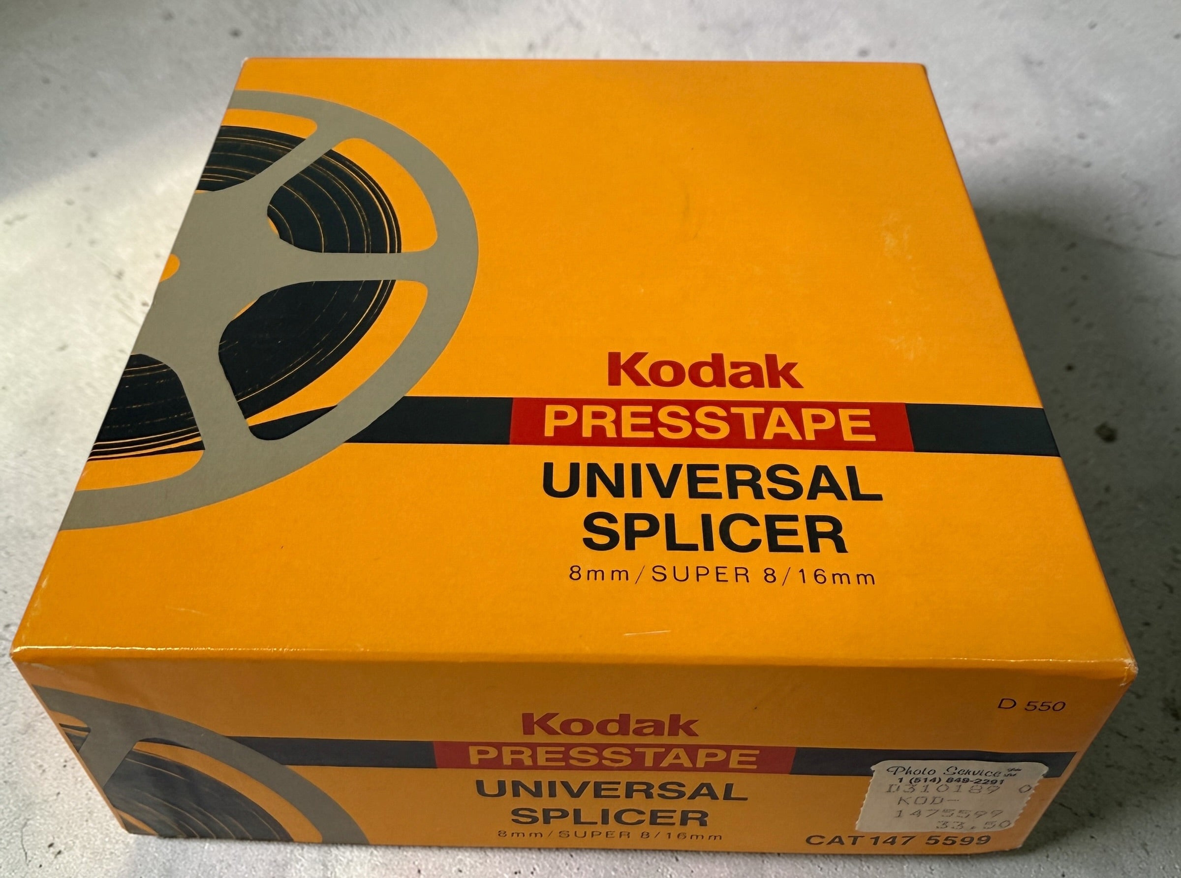 Vintage Kodak film splicer kit with Presstape tabs, 8mm Super 8 16mm editor tool in box, complete analog filmmaking accessory.