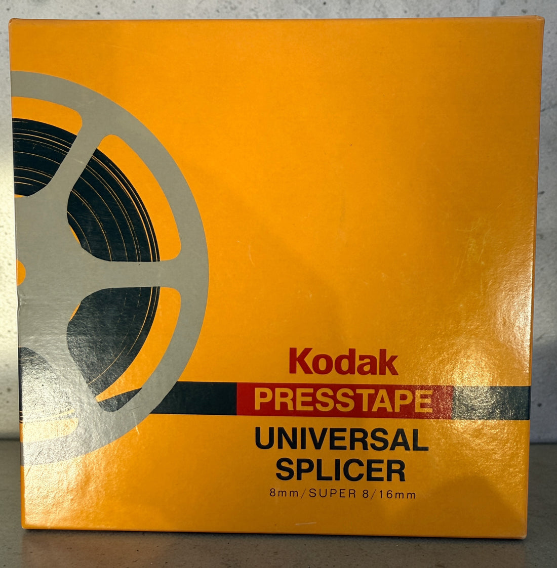 Vintage Kodak film splicer kit with Presstape tabs, 8mm Super 8 16mm editor tool in box, complete analog filmmaking accessory.