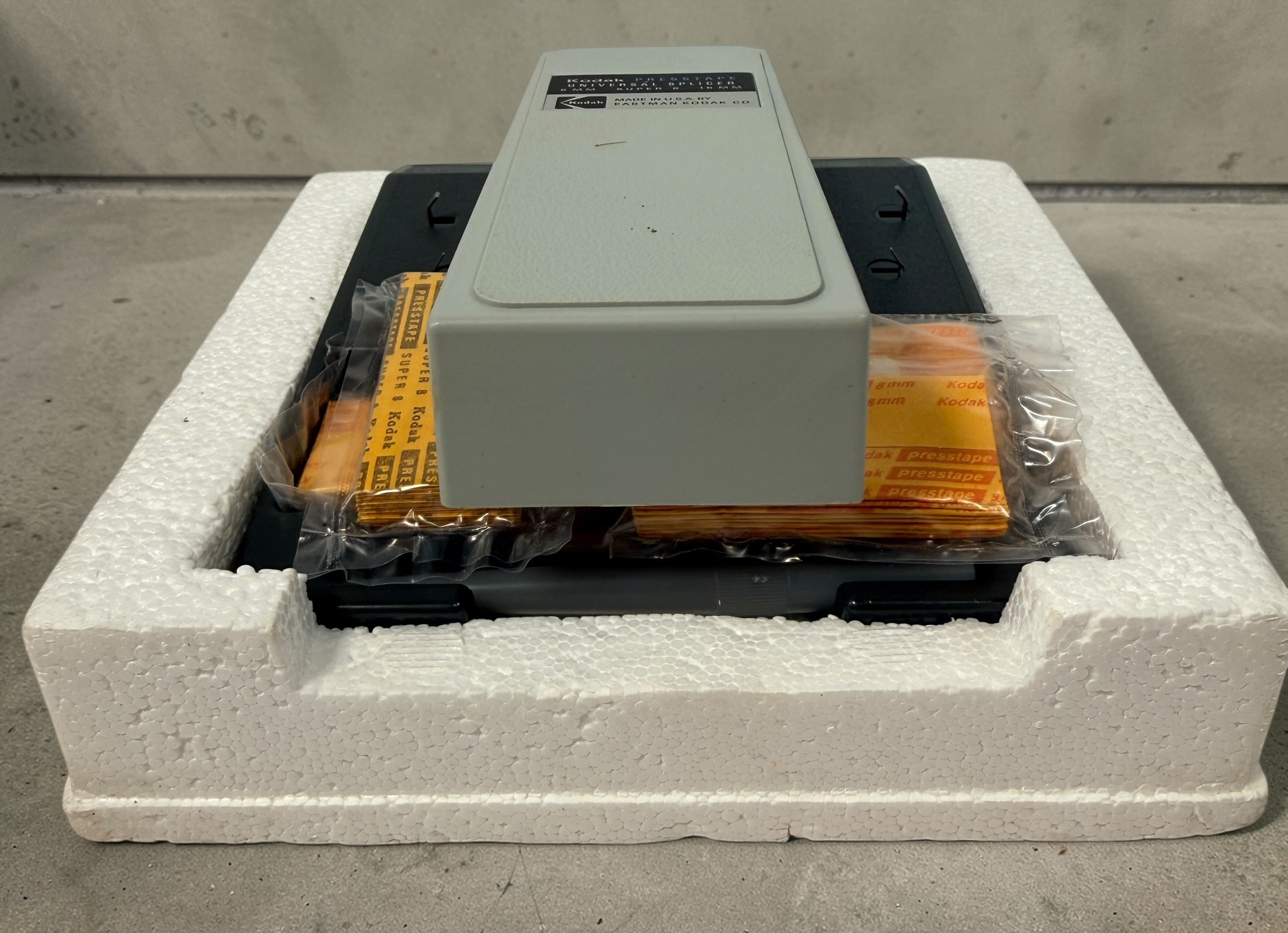 Vintage Kodak film splicer kit with Presstape tabs, 8mm Super 8 16mm editor tool in box, complete analog filmmaking accessory.