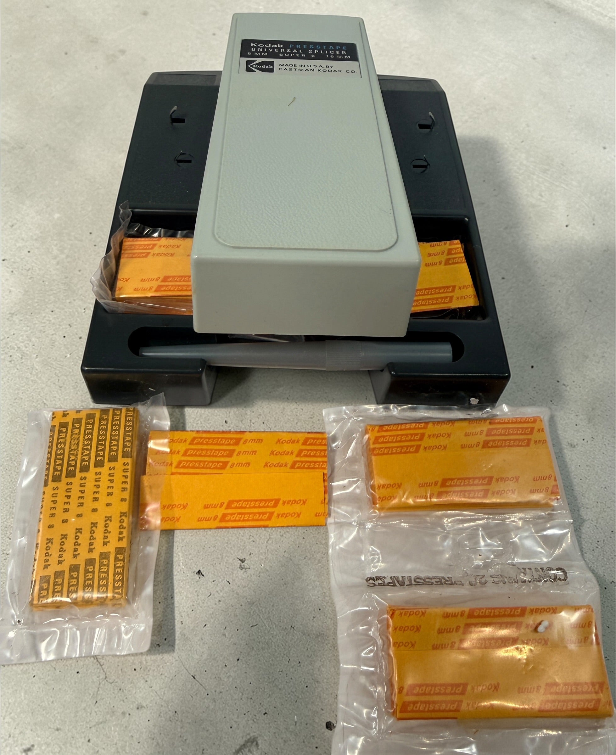 Vintage Kodak film splicer kit with Presstape tabs, 8mm Super 8 16mm editor tool in box, complete analog filmmaking accessory.