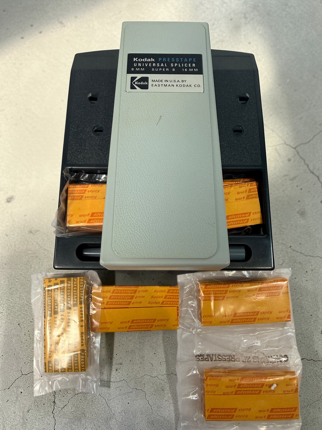 Vintage Kodak film splicer kit with Presstape tabs, 8mm Super 8 16mm editor tool in box, complete analog filmmaking accessory.