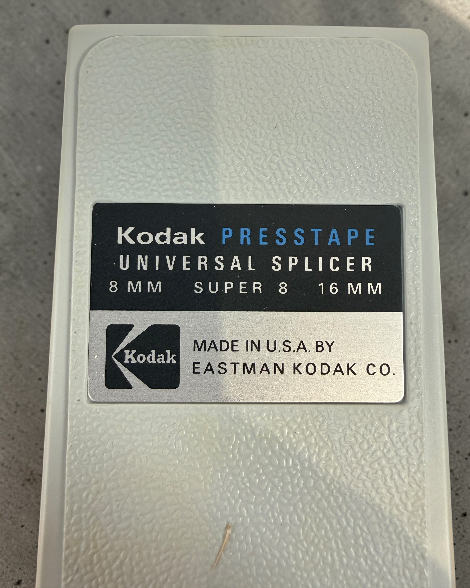 Vintage Kodak film splicer kit with Presstape tabs, 8mm Super 8 16mm editor tool in box, complete analog filmmaking accessory.
