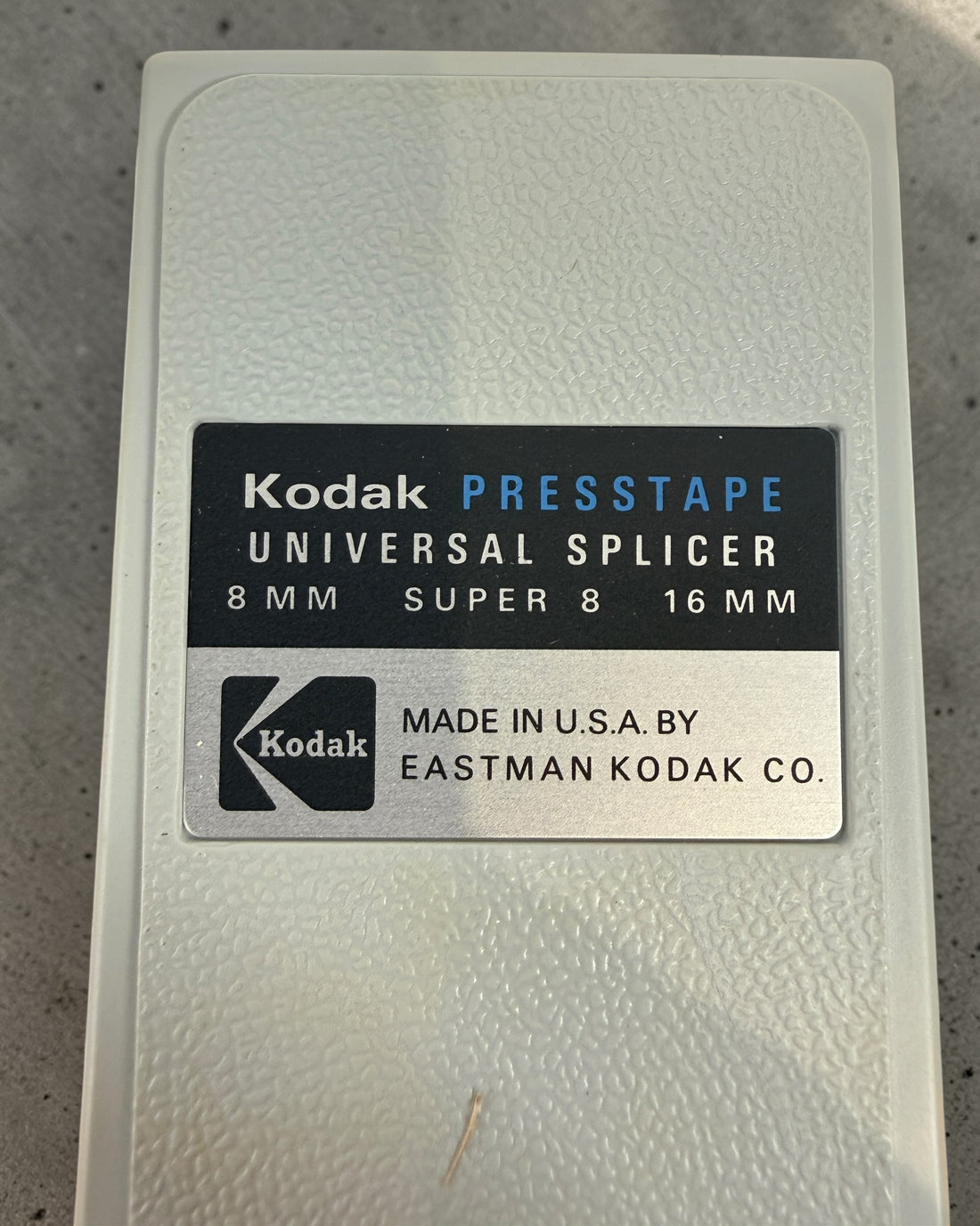 Vintage Kodak film splicer kit with Presstape tabs, 8mm Super 8 16mm editor tool in box, complete analog filmmaking accessory.