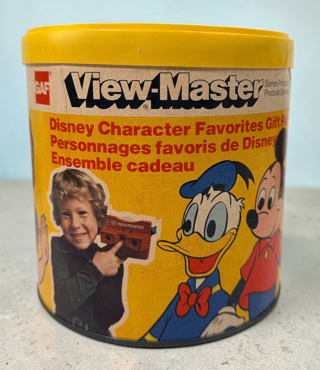 Vintage 1970s GAF View-Master Disney Gift Pak with viewer and reels. Classic 3D toy set with original canister, great collectible condition.