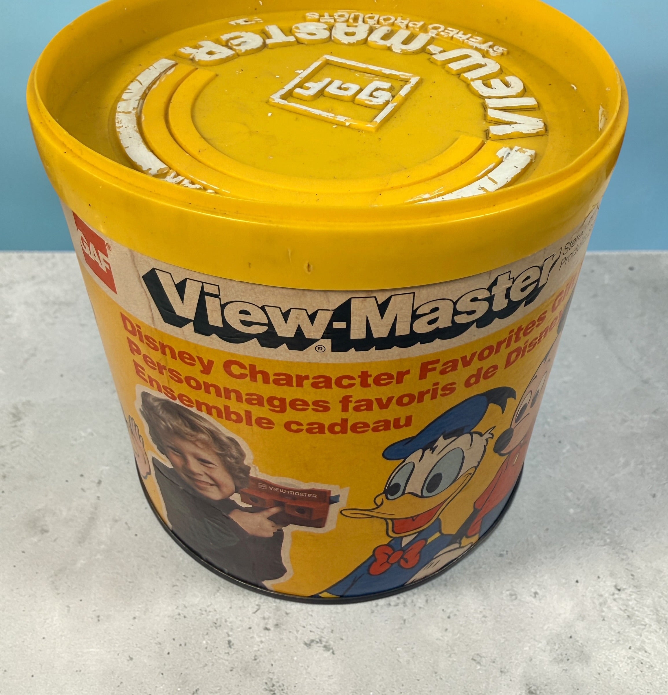 Vintage 1970s GAF View-Master Disney Gift Pak with viewer and reels. Classic 3D toy set with original canister, great collectible condition.