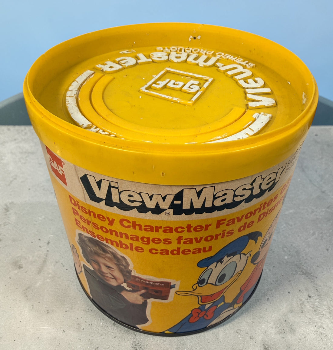 Vintage 1970s GAF View-Master Disney Gift Pak with viewer and reels. Classic 3D toy set with original canister, great collectible condition.