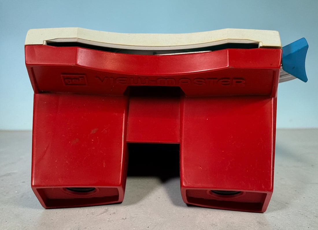 Vintage 1970s GAF View-Master Disney Gift Pak with viewer and reels. Classic 3D toy set with original canister, great collectible condition.