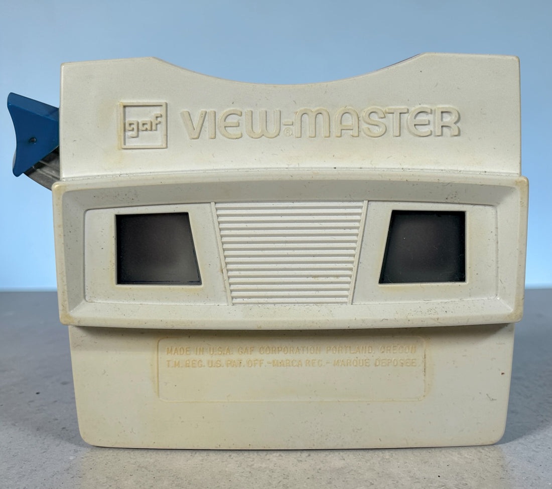 Vintage 1970s GAF View-Master Disney Gift Pak with viewer and reels. Classic 3D toy set with original canister, great collectible condition.