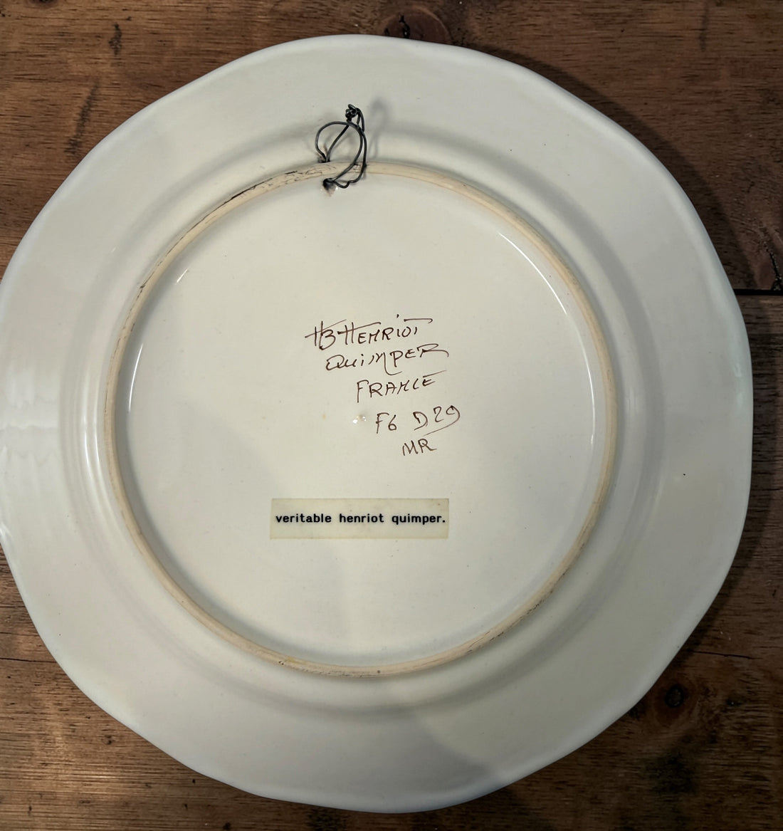 Henriot Quimper hand-painted faience plate with Breton musician motif, vintage French pottery collectible in excellent condition, ideal wall decor.