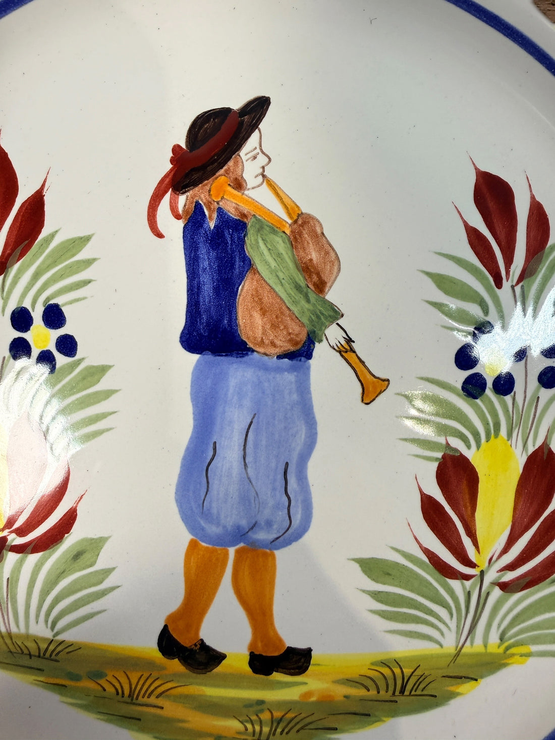 Henriot Quimper hand-painted faience plate with Breton musician motif, vintage French pottery collectible in excellent condition, ideal wall decor.