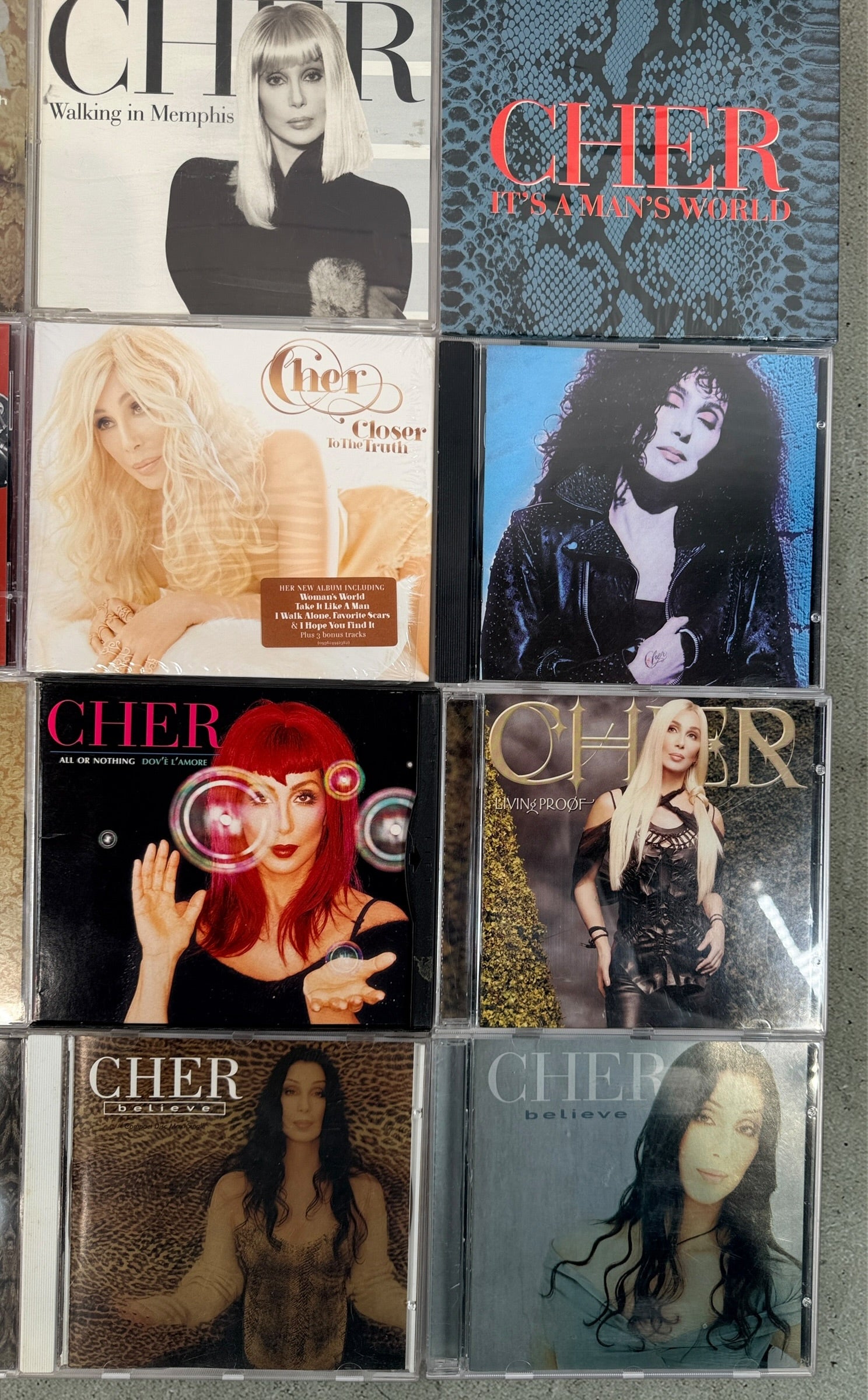 Cher CD lot of 10 albums and singles including Believe and Living Proof. Great starter collection with classic hits. Good condition with light wear.