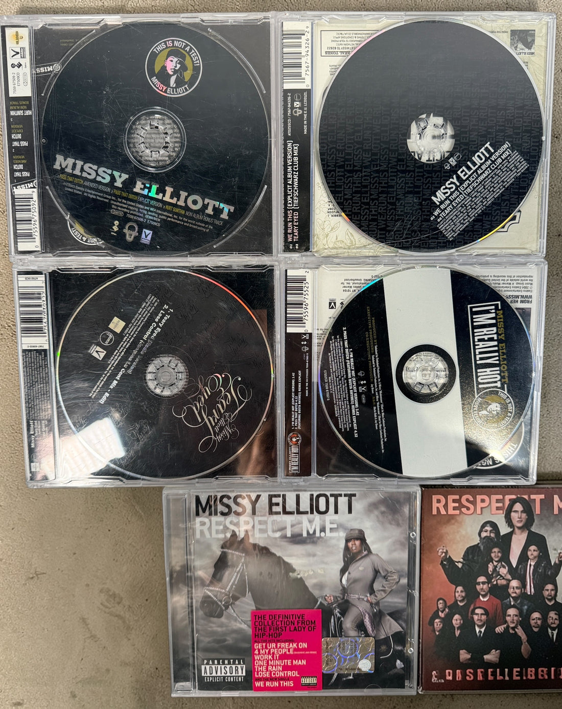 Missy Elliott CD lot featuring Respect M.E. greatest hits and hit singles including Pass That Dutch and We Run This. 2000s hip-hop bundle.