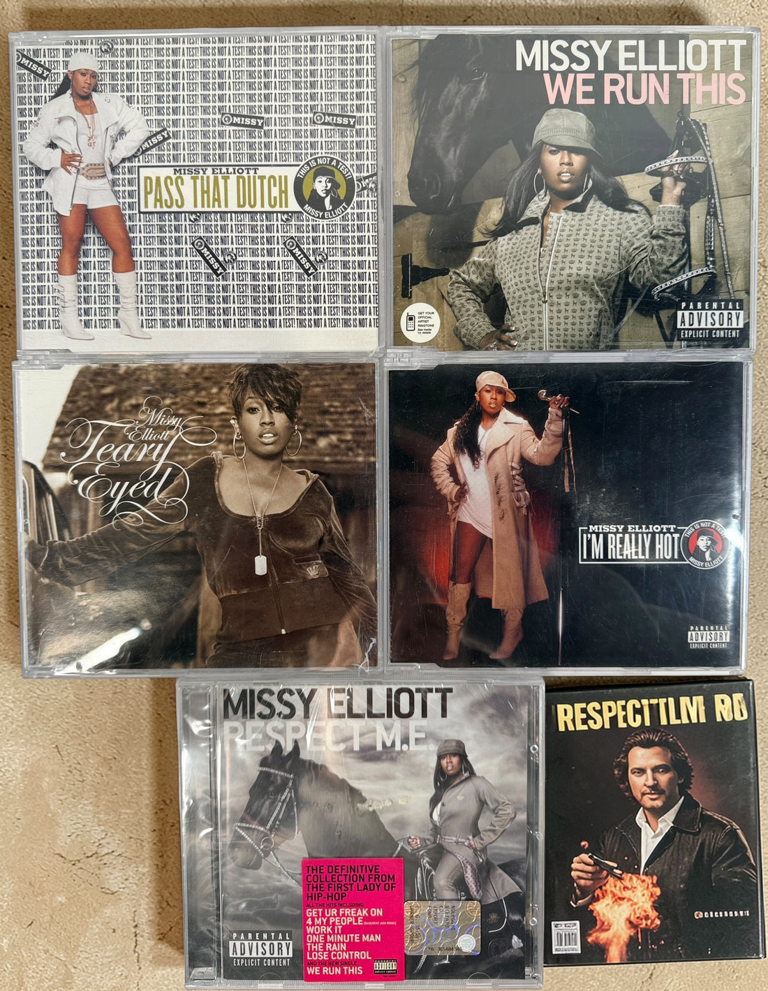 Missy Elliott CD lot featuring Respect M.E. greatest hits and hit singles including Pass That Dutch and We Run This. 2000s hip-hop bundle.