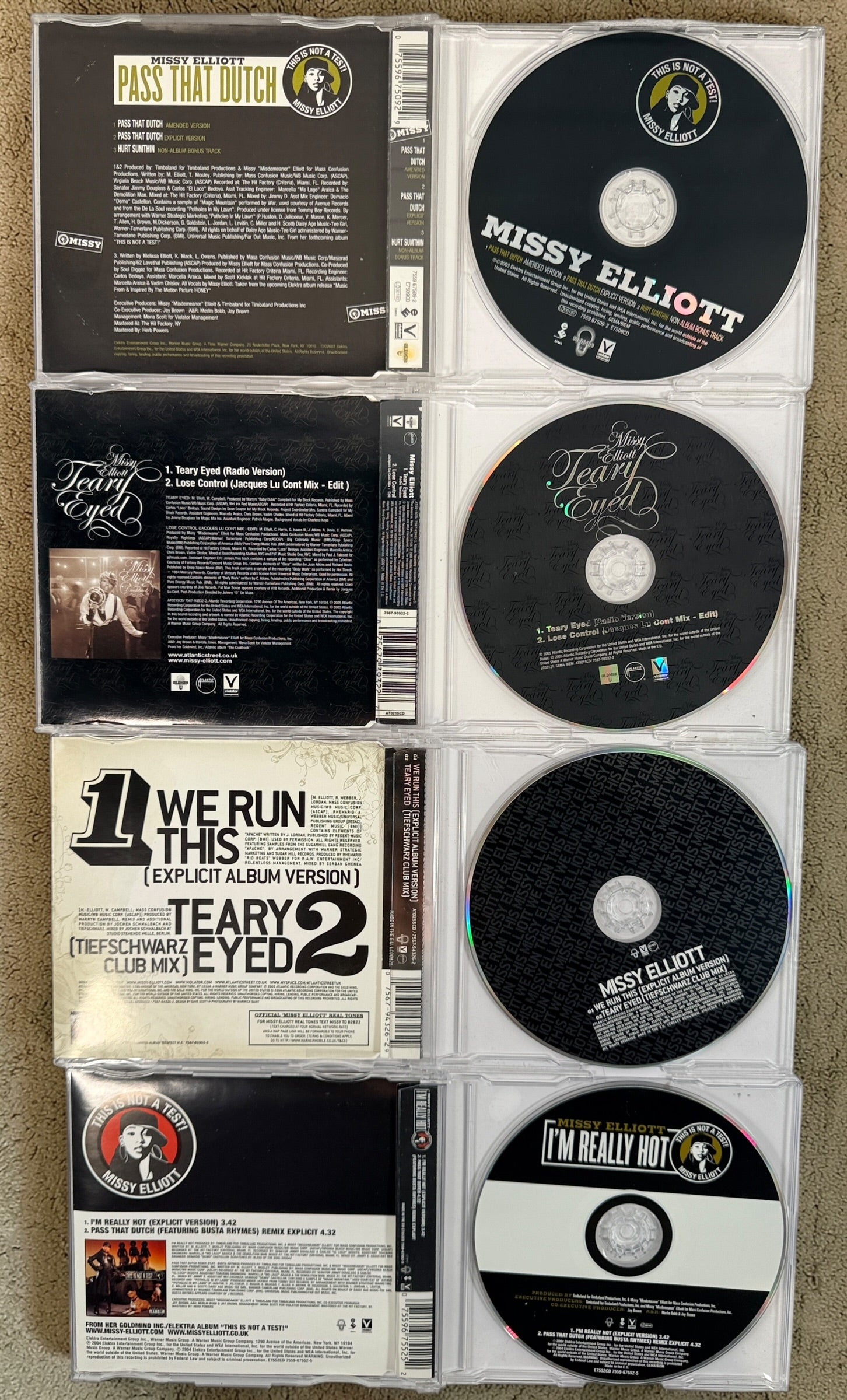 Missy Elliott CD lot featuring Respect M.E. greatest hits and hit singles including Pass That Dutch and We Run This. 2000s hip-hop bundle.