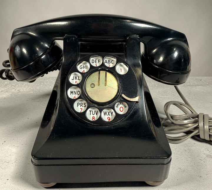 Vintage Northern Electric rotary telephone in black Bakelite, classic Canadian mid-century design. Great display piece or restoration project.
