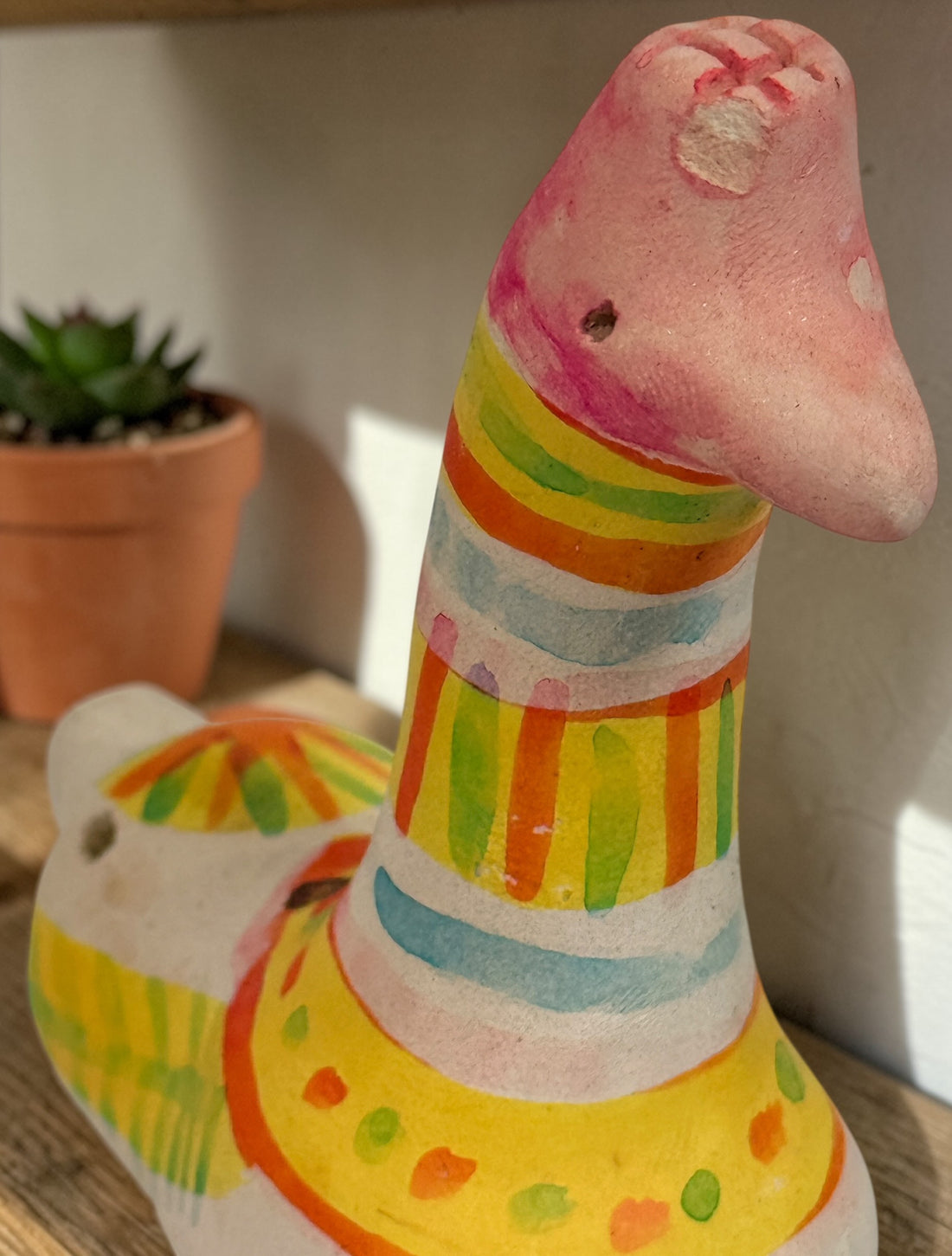 Signed Filimonovo clay whistle by Seregina, Soviet folk art bird figurine with vibrant hand-painted design, collectible Russian pottery from the 1990s.