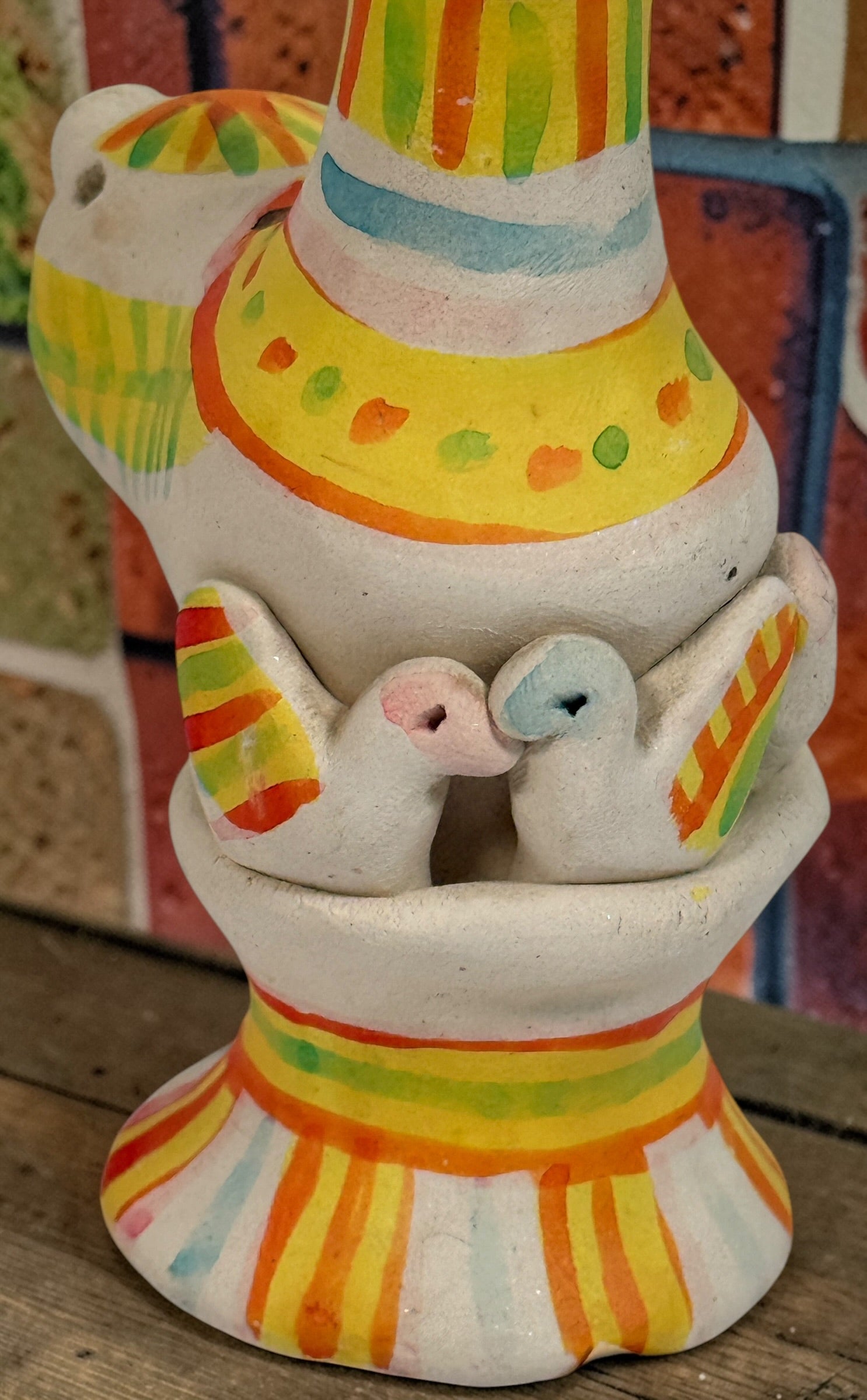 Signed Filimonovo clay whistle by Seregina, Soviet folk art bird figurine with vibrant hand-painted design, collectible Russian pottery from the 1990s.
