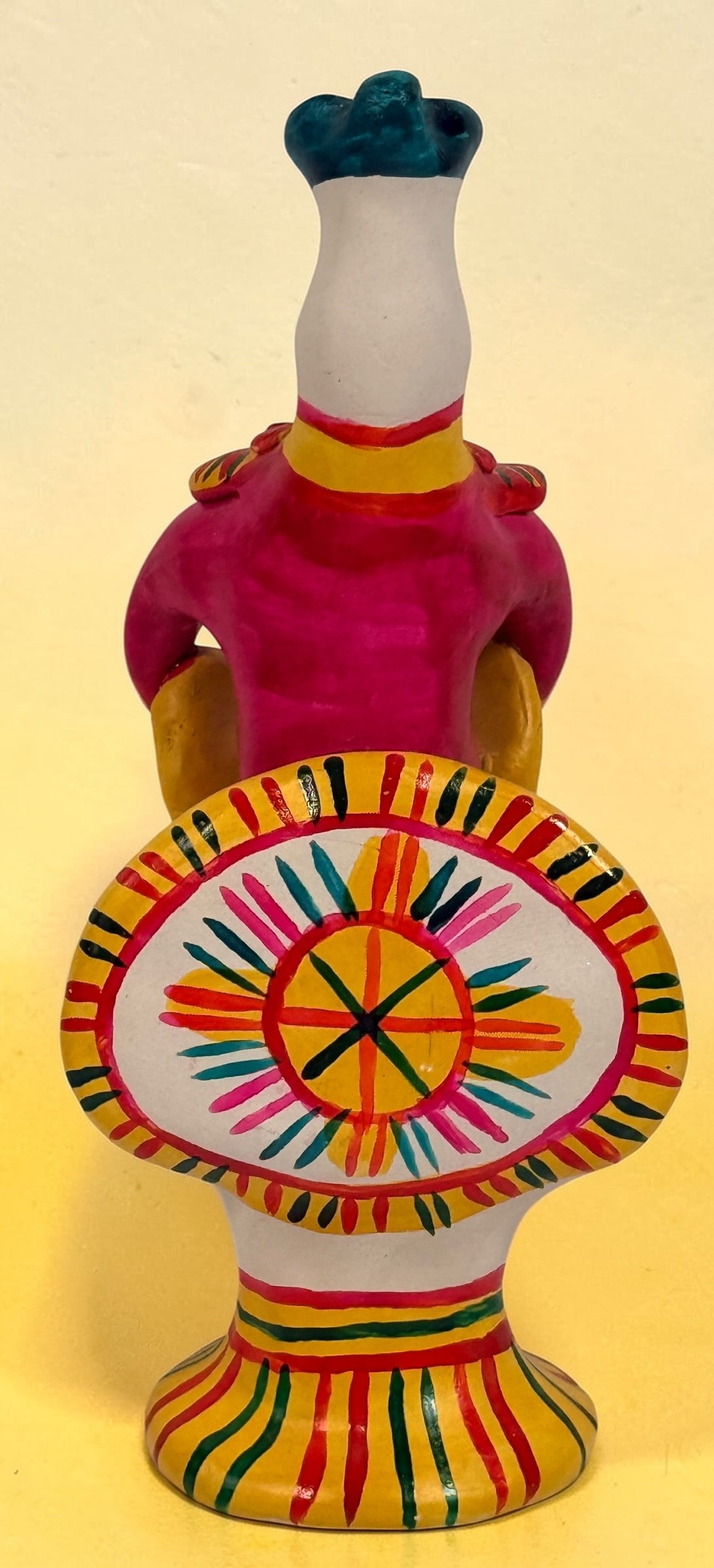 Vintage Russian folk art ceramic figurine, hand painted seated woman with basket, colorful Eastern European decorative pottery collectible.