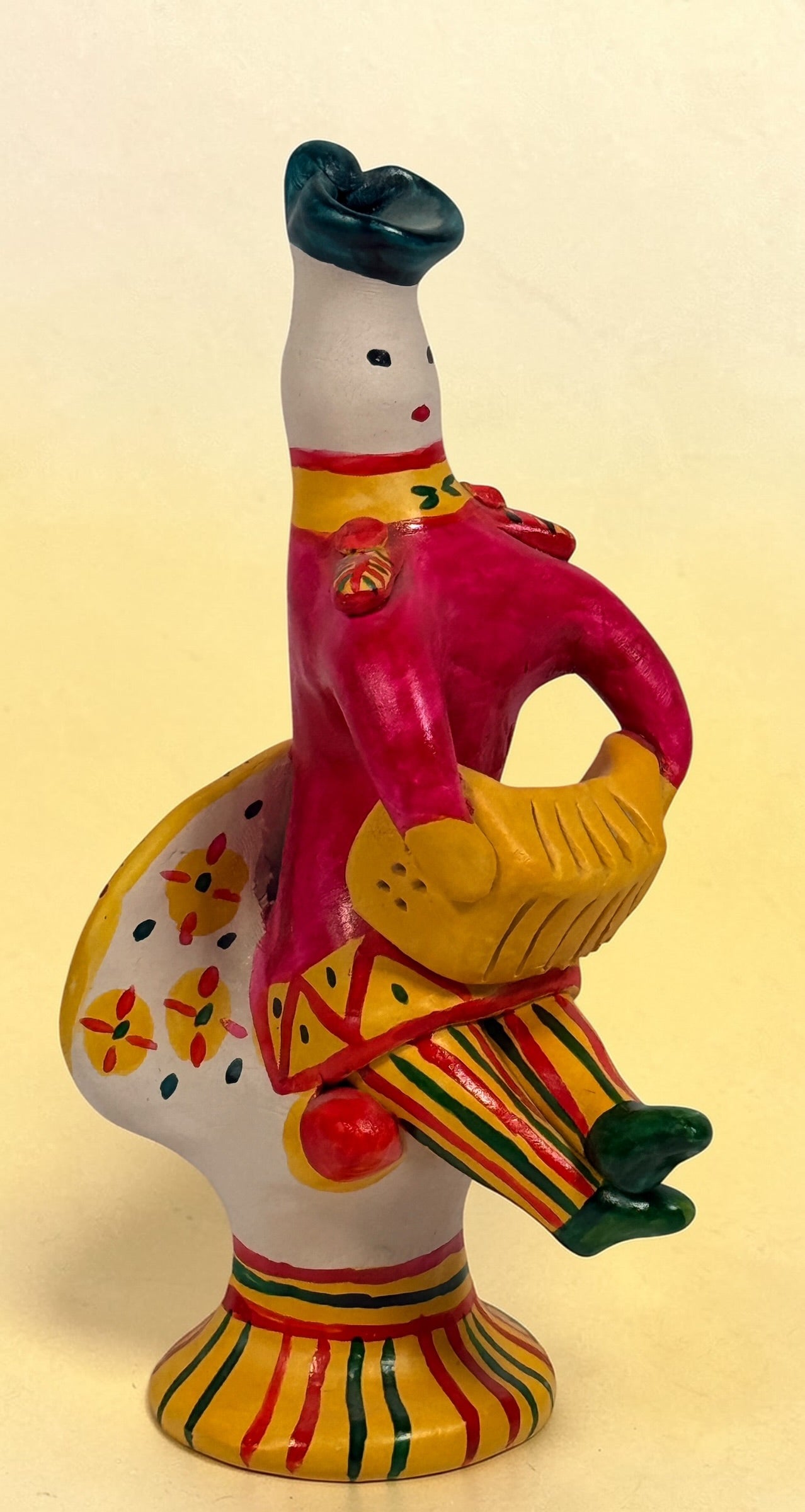 Vintage Russian folk art ceramic figurine, hand painted seated woman with basket, colorful Eastern European decorative pottery collectible.