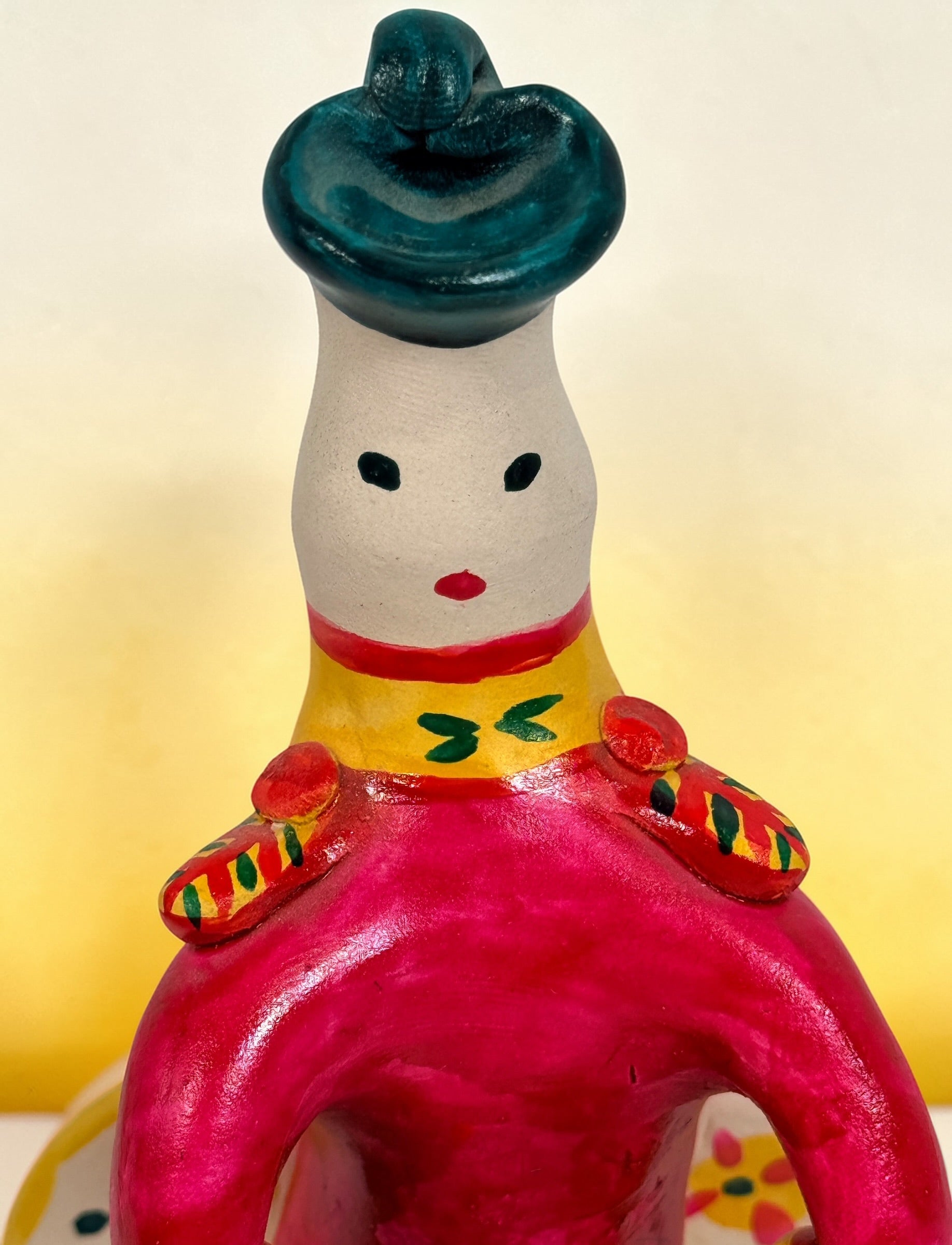 Vintage Russian folk art ceramic figurine, hand painted seated woman with basket, colorful Eastern European decorative pottery collectible.