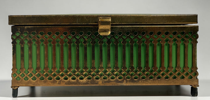 Vintage Mele Hollywood Regency jewelry box with brass filigree and green glass. Red velvet interior with compartments. Decorative mid-century piece.