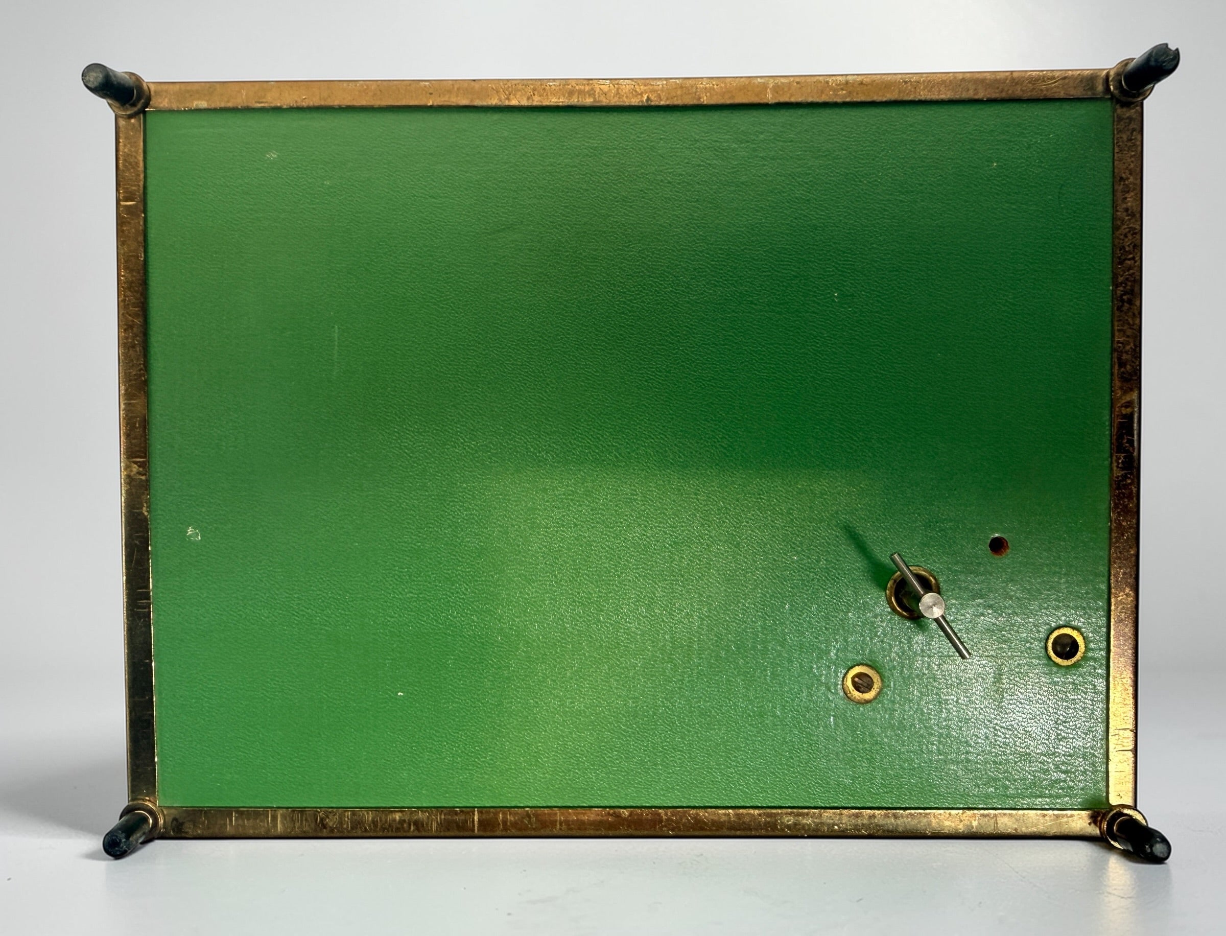 Vintage Mele Hollywood Regency jewelry box with brass filigree and green glass. Red velvet interior with compartments. Decorative mid-century piece.