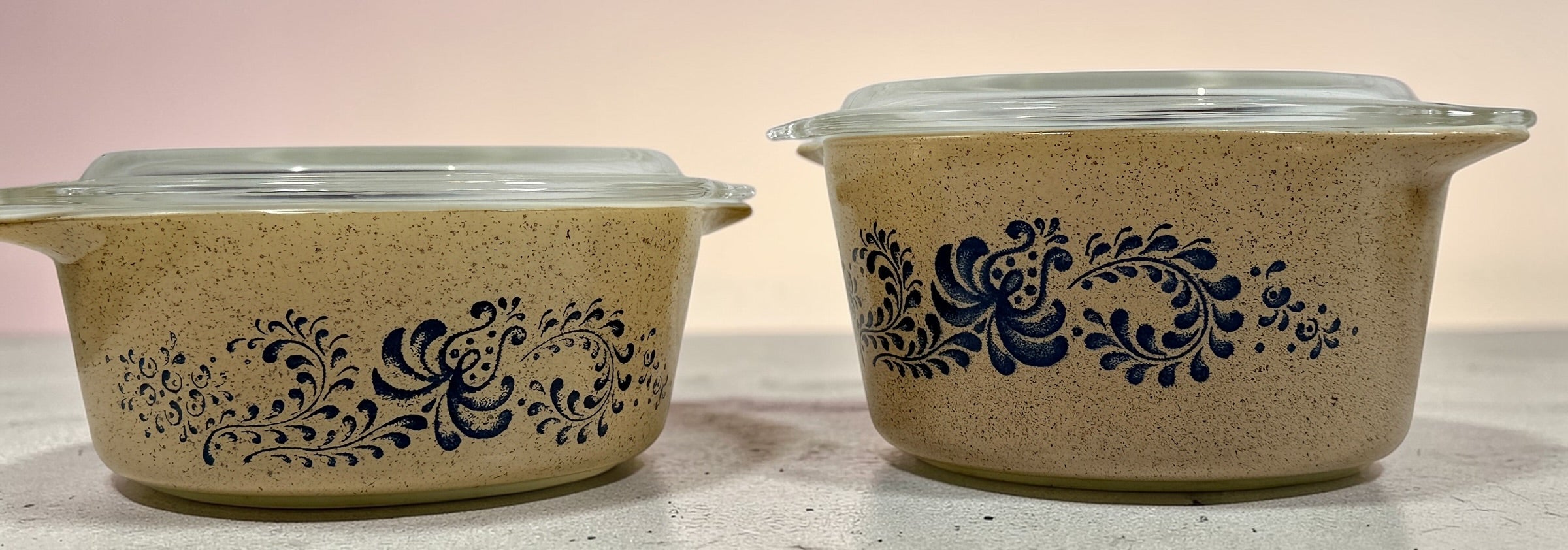 Vintage Pyrex Homestead blue floral mixing bowls and casserole dishes with lids. Classic farmhouse kitchenware set, durable glass, collectible and practical.