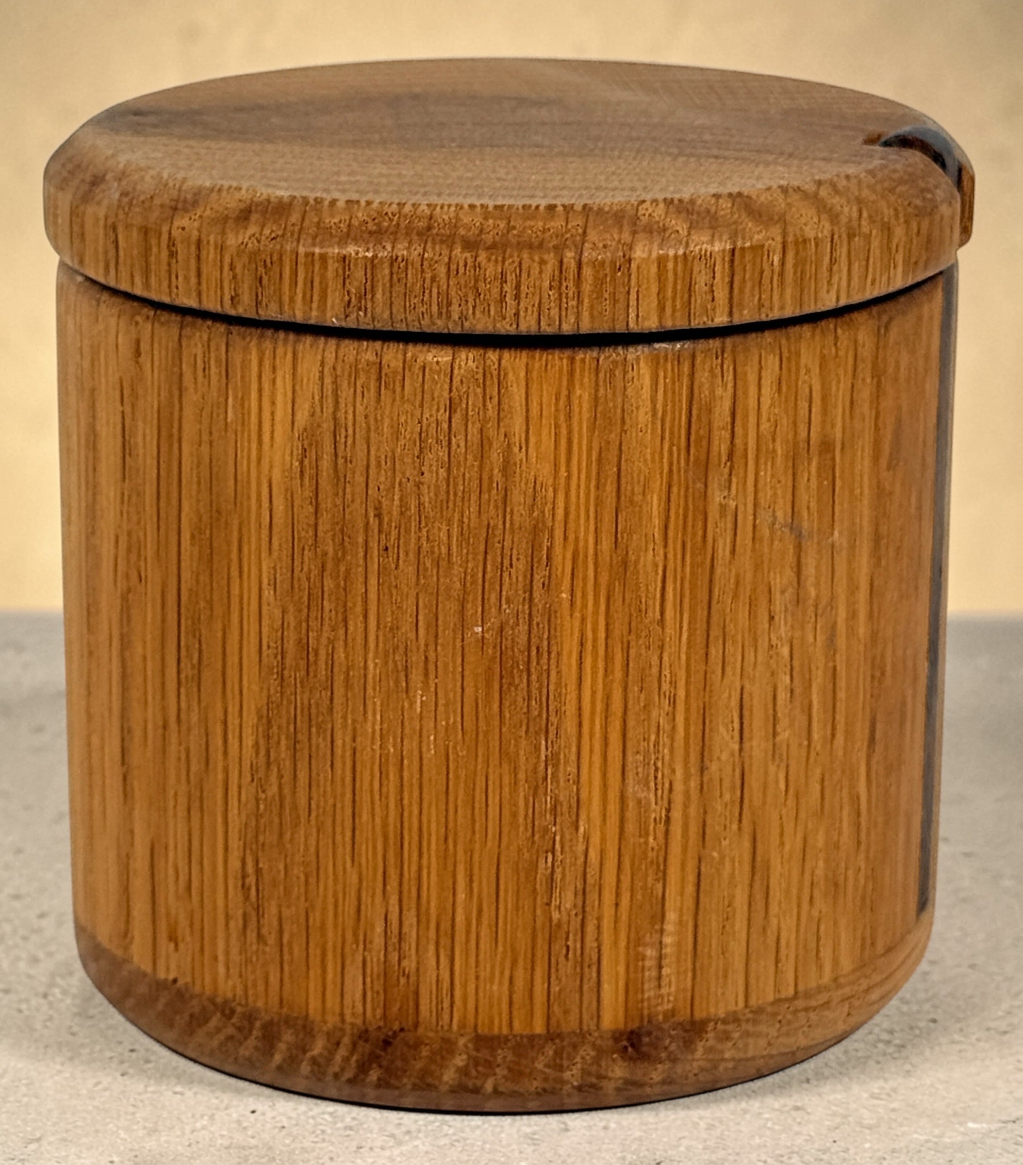 Vintage oak salt cellar with turned wood construction and minimalist design. Functional lidded kitchen container ideal for salt, spices, or countertop storage.