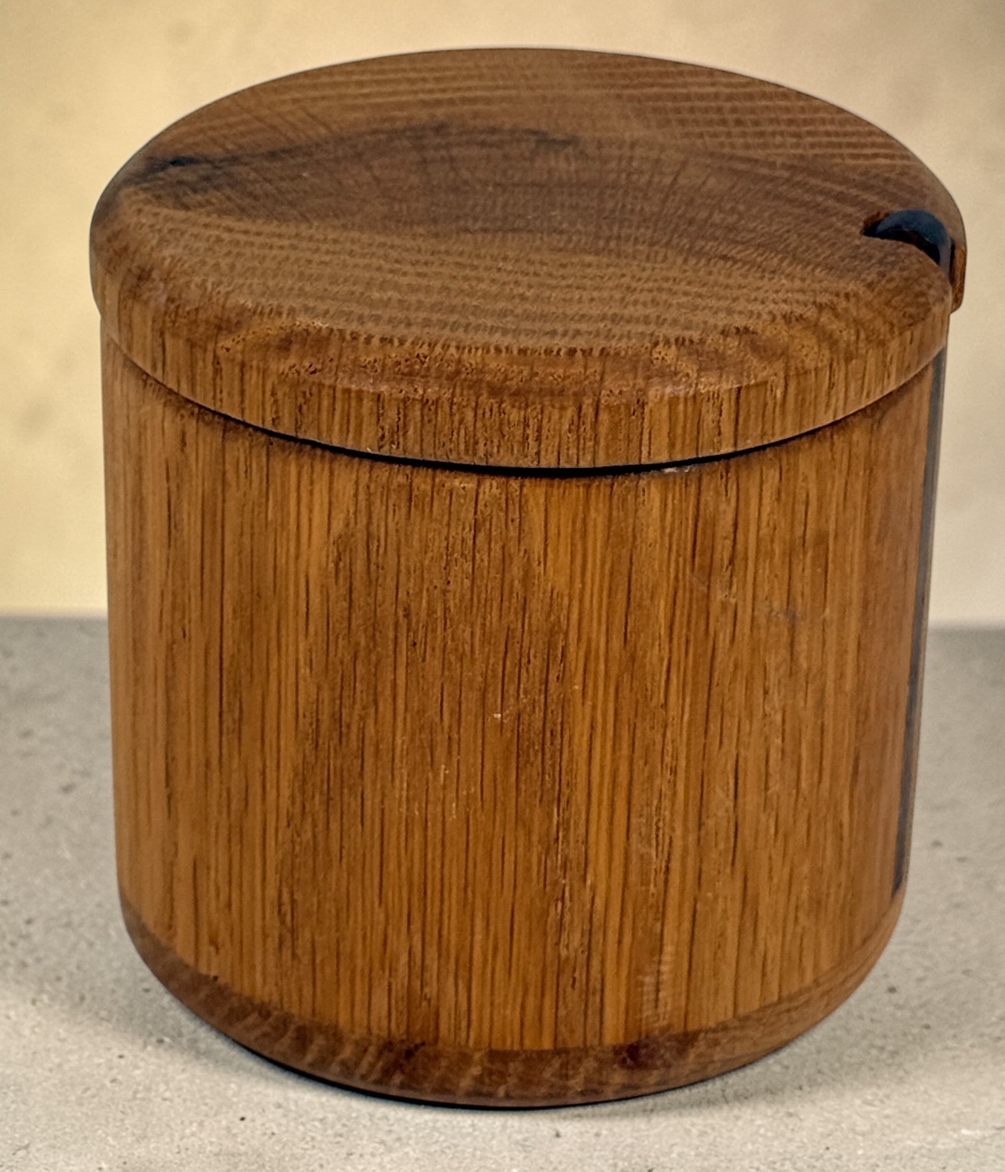 Vintage oak salt cellar with turned wood construction and minimalist design. Functional lidded kitchen container ideal for salt, spices, or countertop storage.