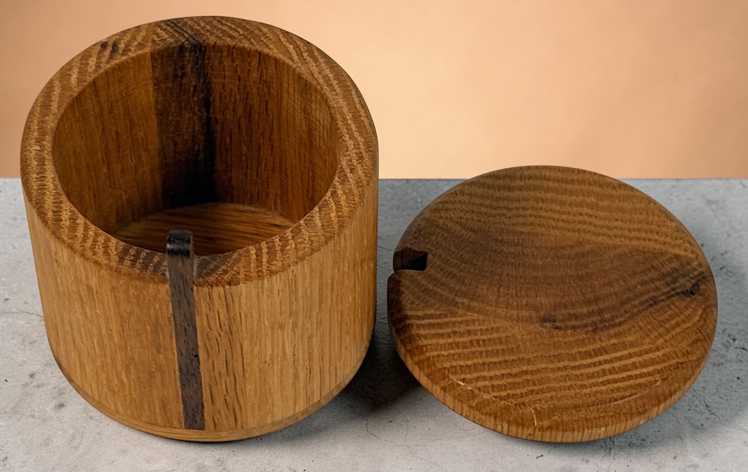 Vintage oak salt cellar with turned wood construction and minimalist design. Functional lidded kitchen container ideal for salt, spices, or countertop storage.