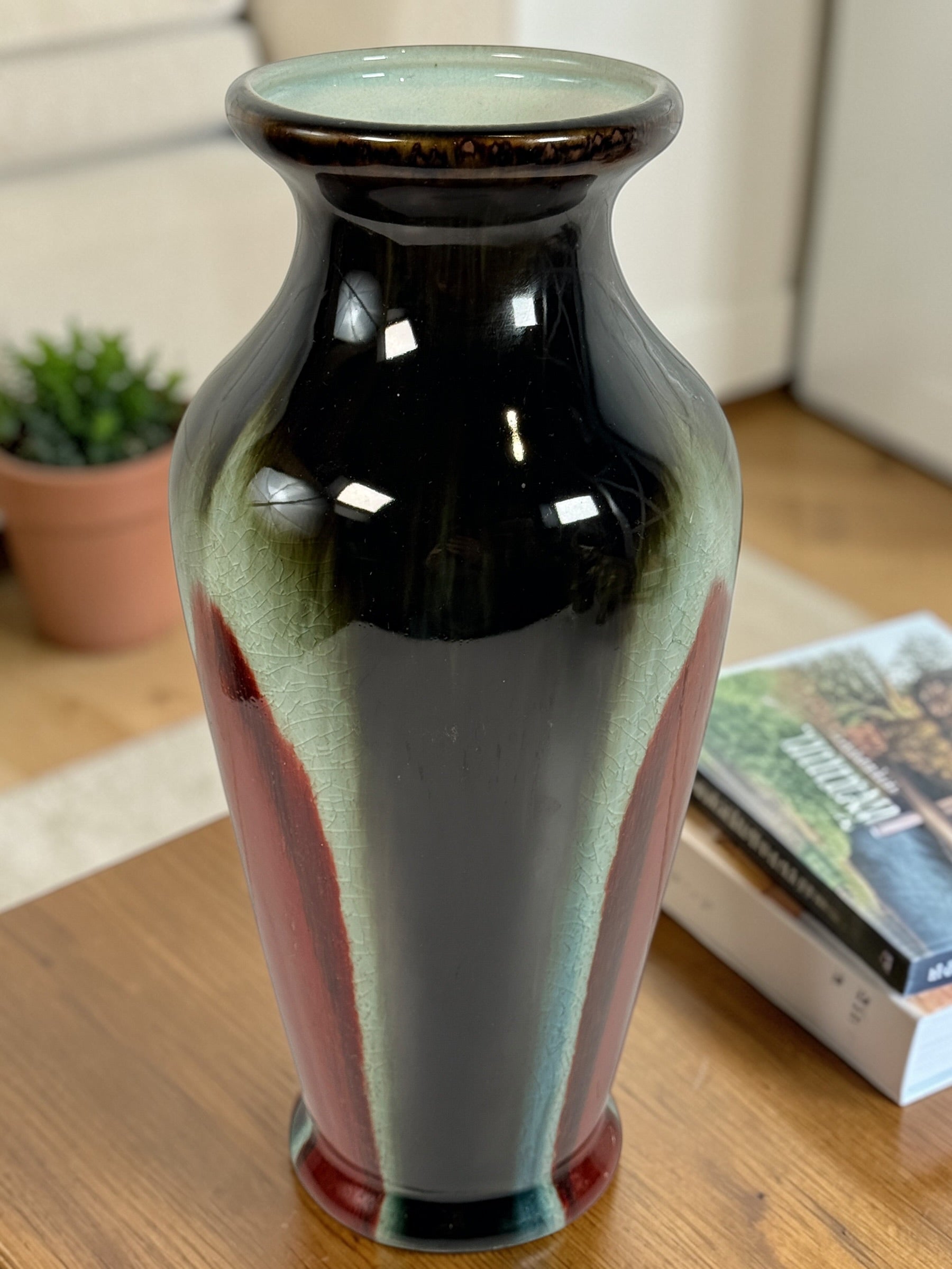 Vintage mid century studio pottery vase with bold red, black and green drip glaze. Decorative ceramic statement piece with crackle finish and modern appeal.