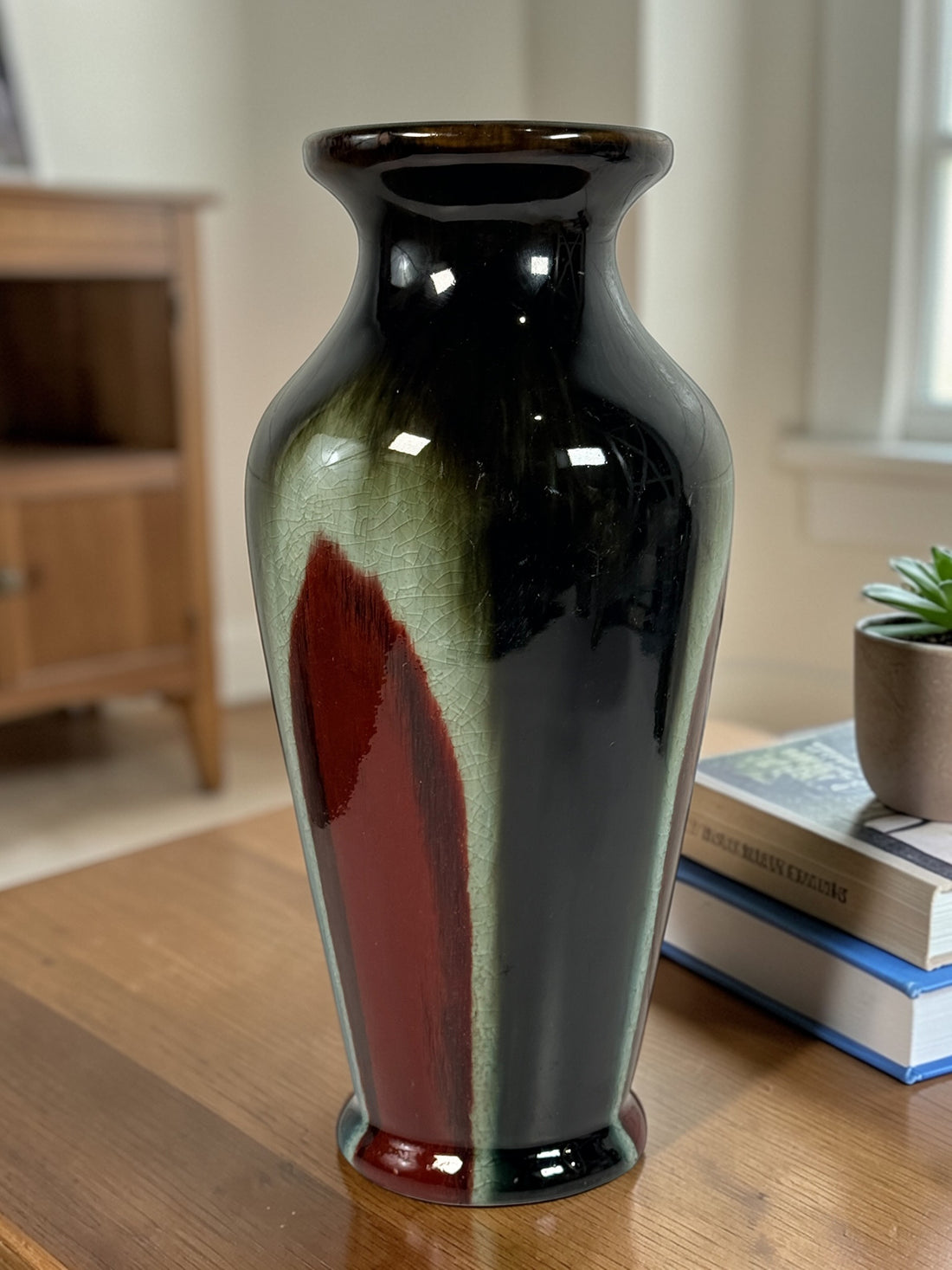 Vintage mid century studio pottery vase with bold red, black and green drip glaze. Decorative ceramic statement piece with crackle finish and modern appeal.