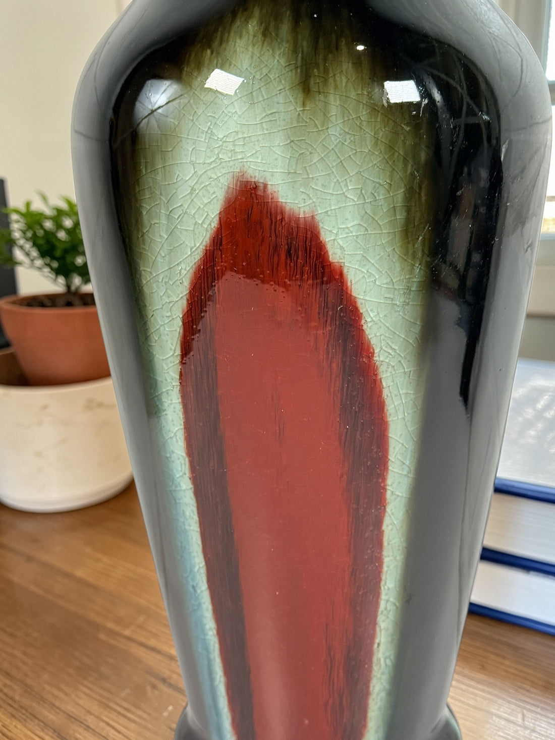 Vintage mid century studio pottery vase with bold red, black and green drip glaze. Decorative ceramic statement piece with crackle finish and modern appeal.