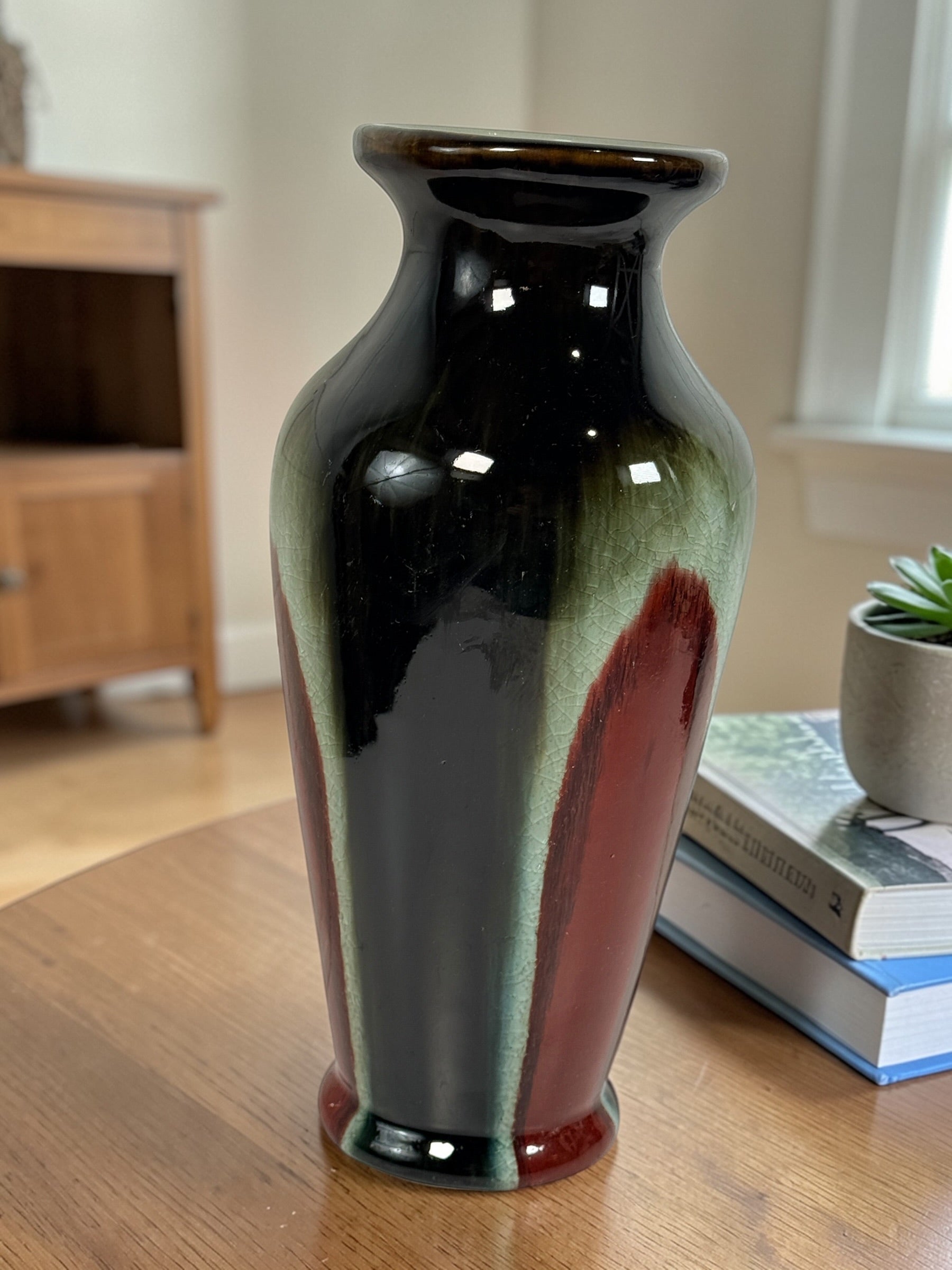 Vintage mid century studio pottery vase with bold red, black and green drip glaze. Decorative ceramic statement piece with crackle finish and modern appeal.