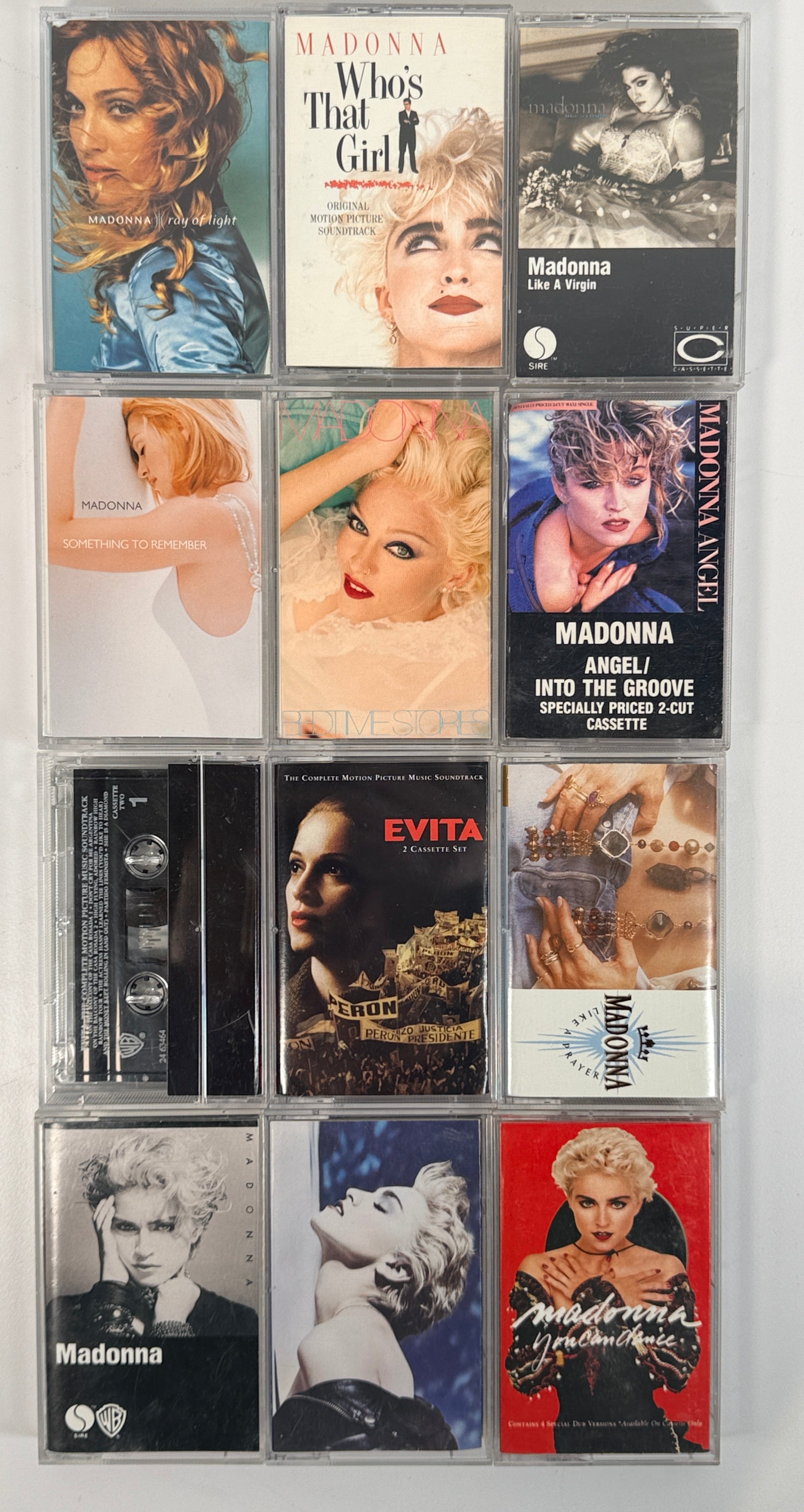 Vintage Madonna cassette tape lot featuring 12 albums from the 80s and 90s including Like a Virgin, True Blue, and Ray of Light, complete with cases.
